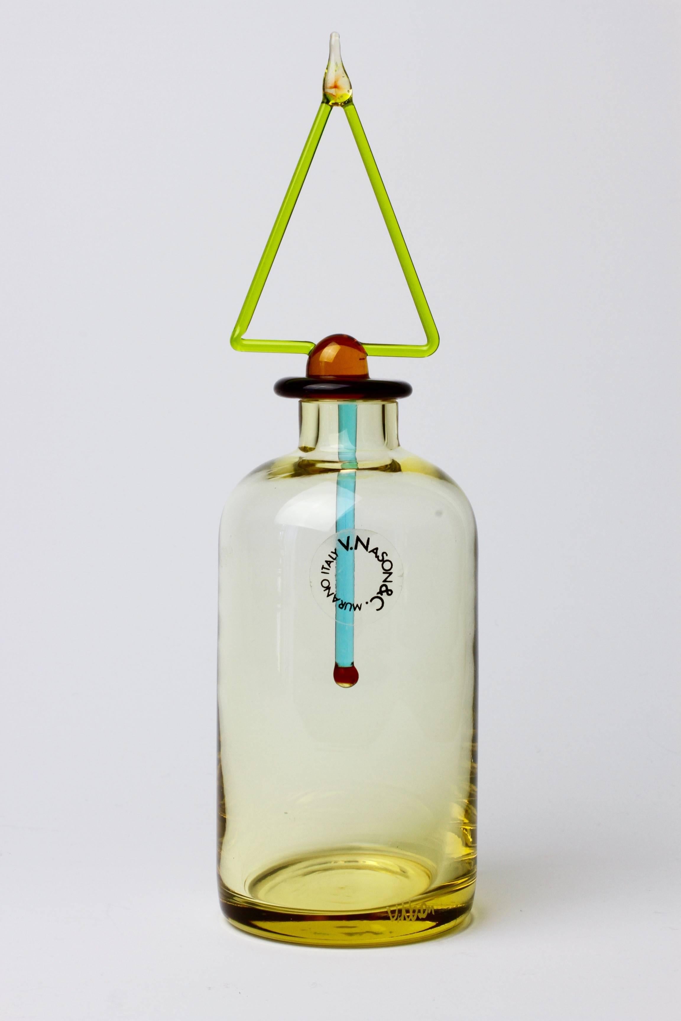 A beautiful little perfume bottle by V. Nason for V. Nason & Co, circa 1989-1990.

Made of mouth blown yellow Murano glass - the bottle features the original colourful stopper/applicator. The design is particularly similar to those of Ettore