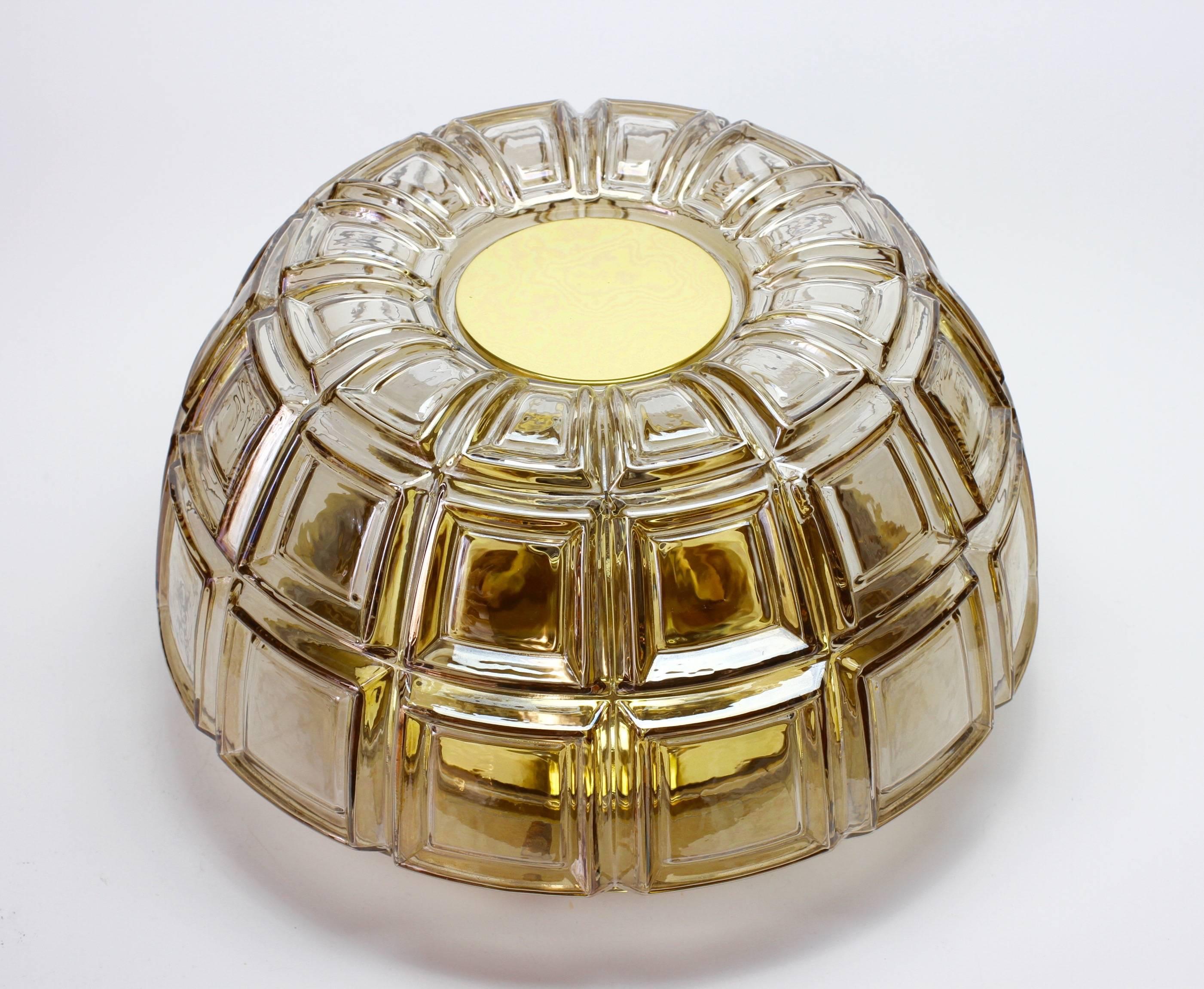 A stunning, vibrant and funky vintage pair wall lights or sconces by iconic German manufacturer Glashütte Limburg, circa 1975-1985. Featuring geometric shaped mouth blown Topaz toned textured glass elements with polished brass mounts. 

Each light