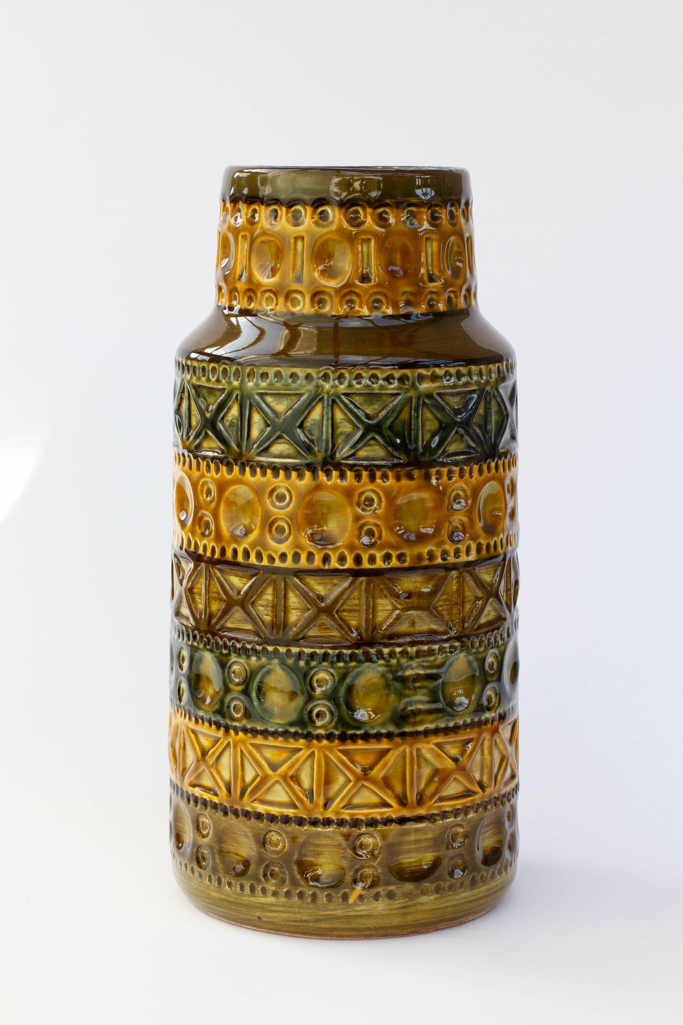 Beautiful vintage vase attributed to designer Bodo Mans and produced by Bay Keramik in the early to mid-1970s. The Inca style relief pattern, captured in a mustard yellow or green, looks somehow Aztec like whilst maintaining a modern feel. This