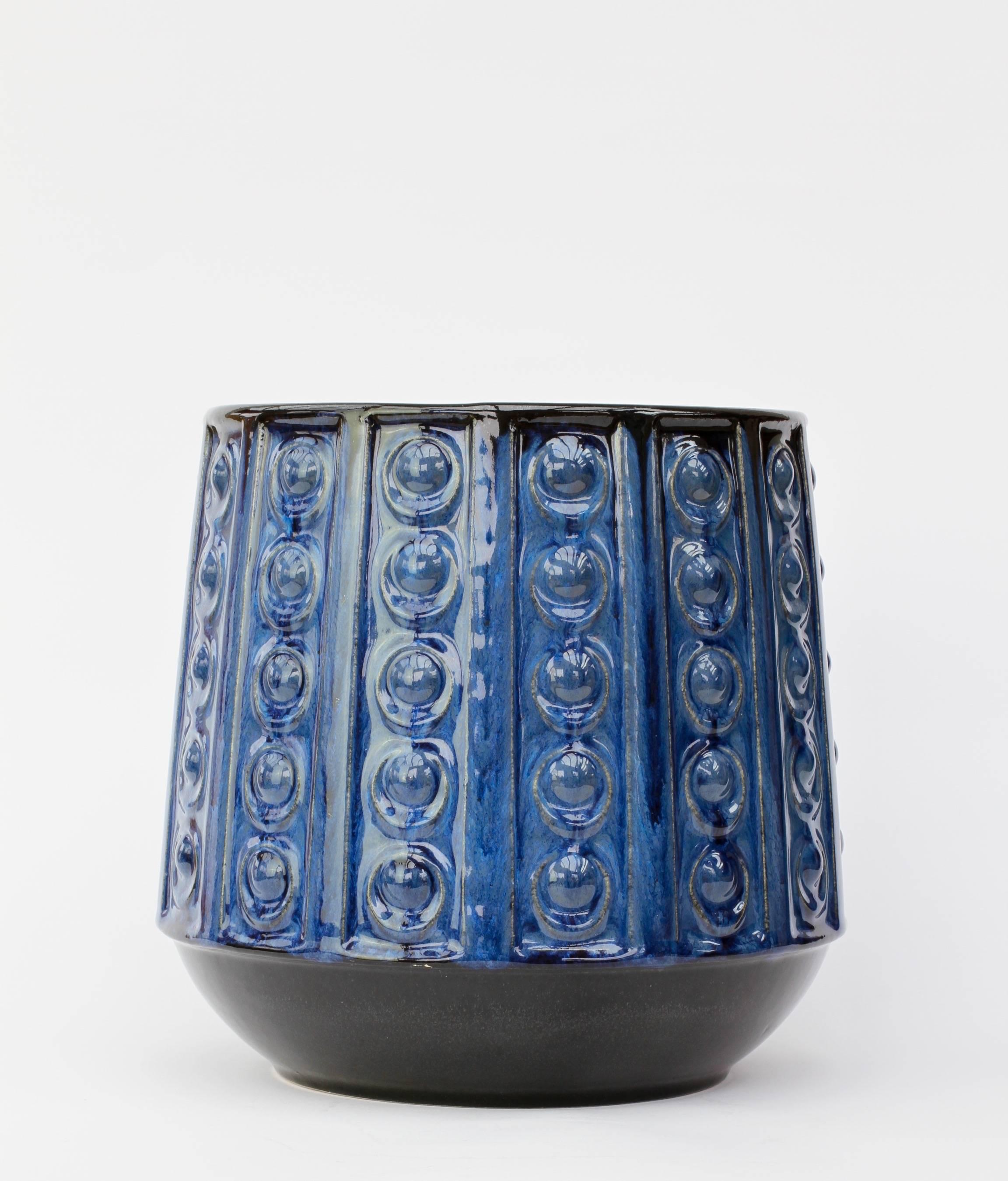 A beautiful, large plant pot or flower vase in striking blue over dark, almost black, brown glaze with an embossed pattern - shape number 4121-20, produced by Jasba Pottery in the mid-1970s.

This vase makes a fantastic, striking statement when