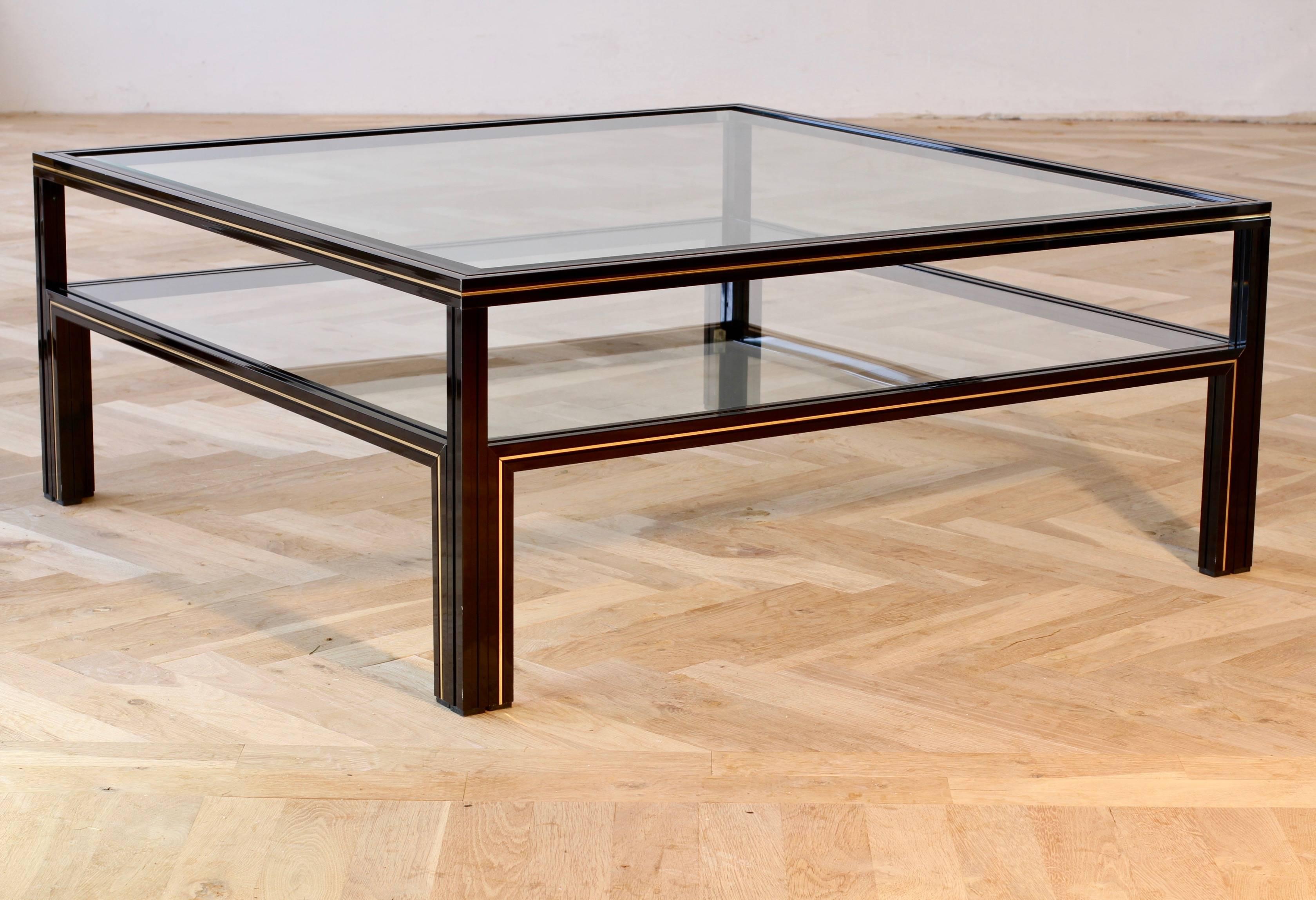 Stunning large, two-tiered square centre coffee table by Paris based French designer Pierre Vandel featuring a double shelved frame made of black powder coated aluminium, making it light whilst extremely strong and durable. The legs and top sections