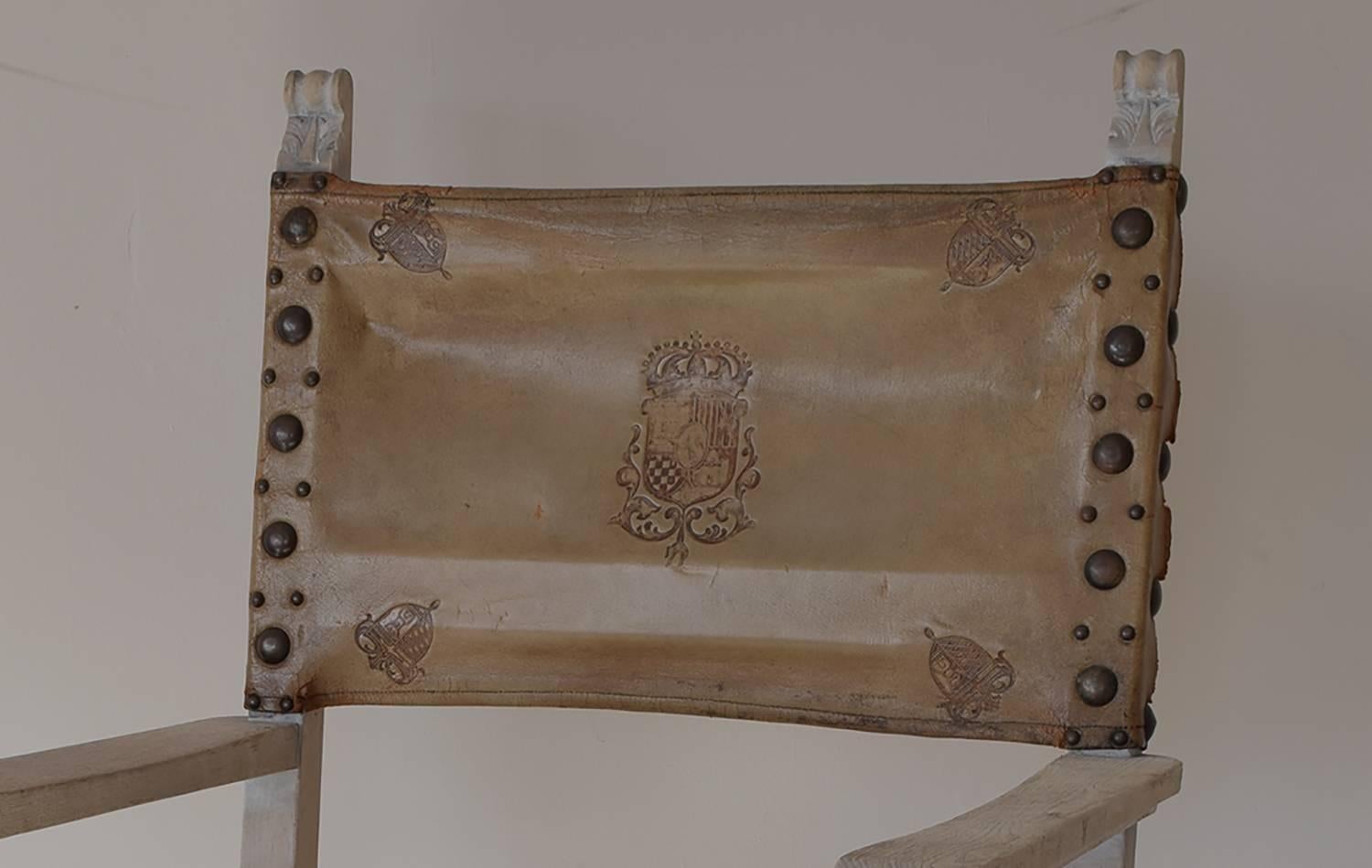 
Limed oak frame with the original upholstery.

Wonderful colour of distressed cream leather.

Great oversized gilded brass studs.

The armorial provenance is unknown.