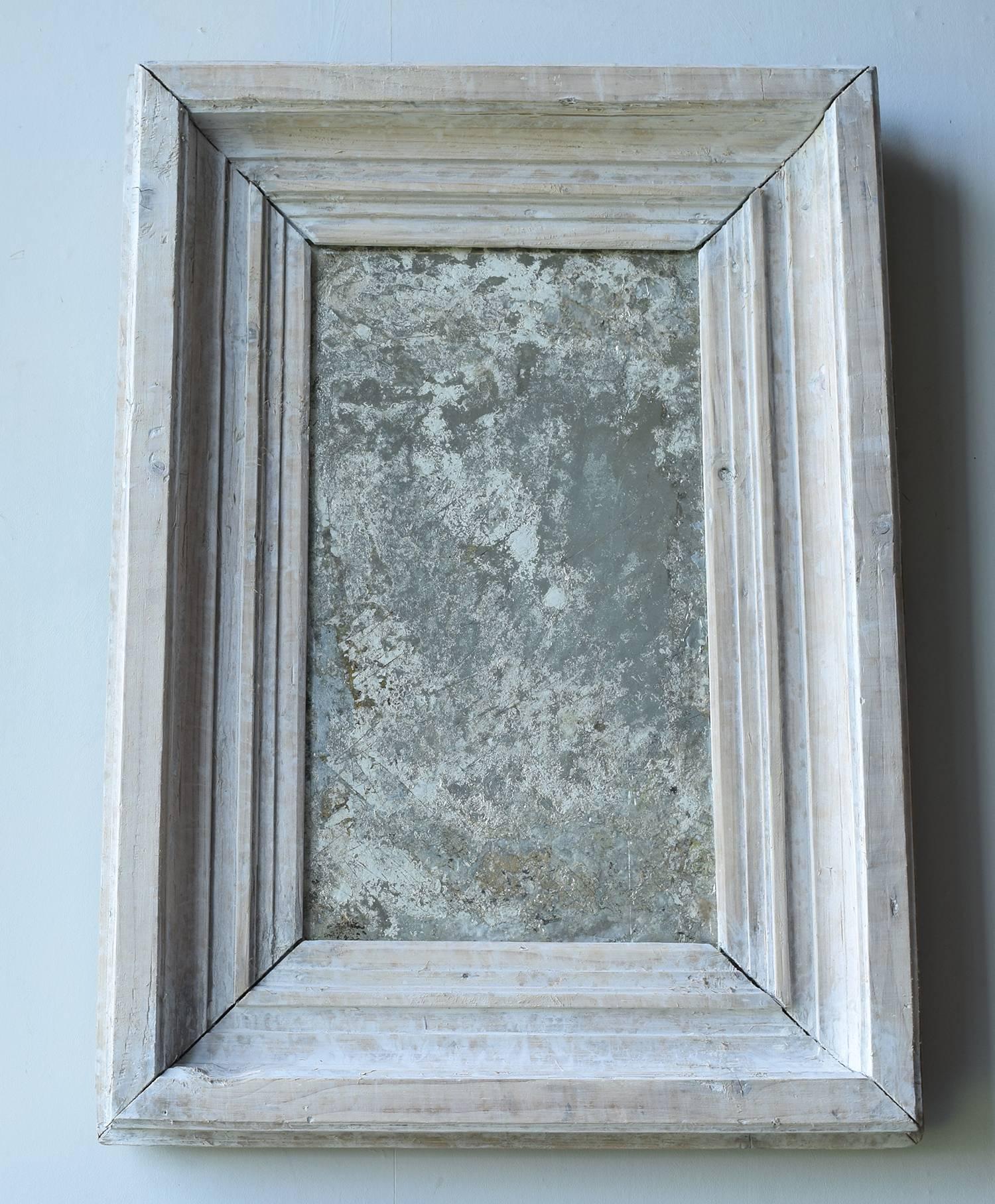 
Wonderfully distressed mirror which has the look of an abstract painting.

The frame is antique lime-washed pine.