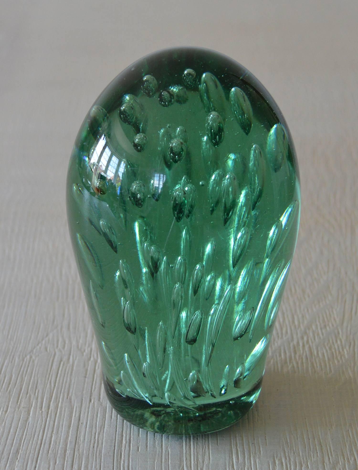 Wonderful piece of green glass with a bubble effect interior.

It can be used as a paperweight, doorstop or simply as a piece of sculpture.