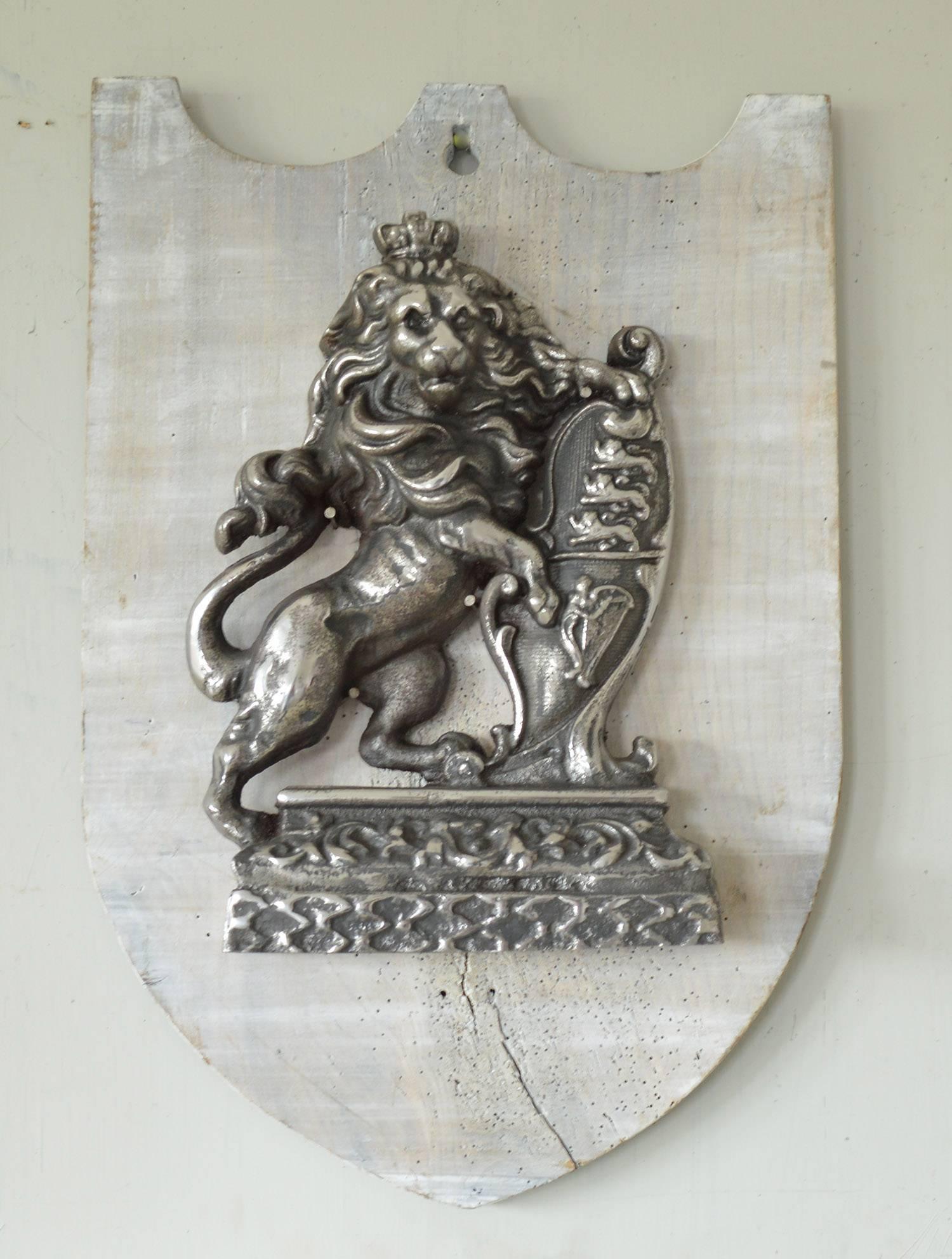 
Wonderful polished cast iron wall-mounted armorial.

Fixed to a distressed shield shaped painted panel which is also circa 1860.