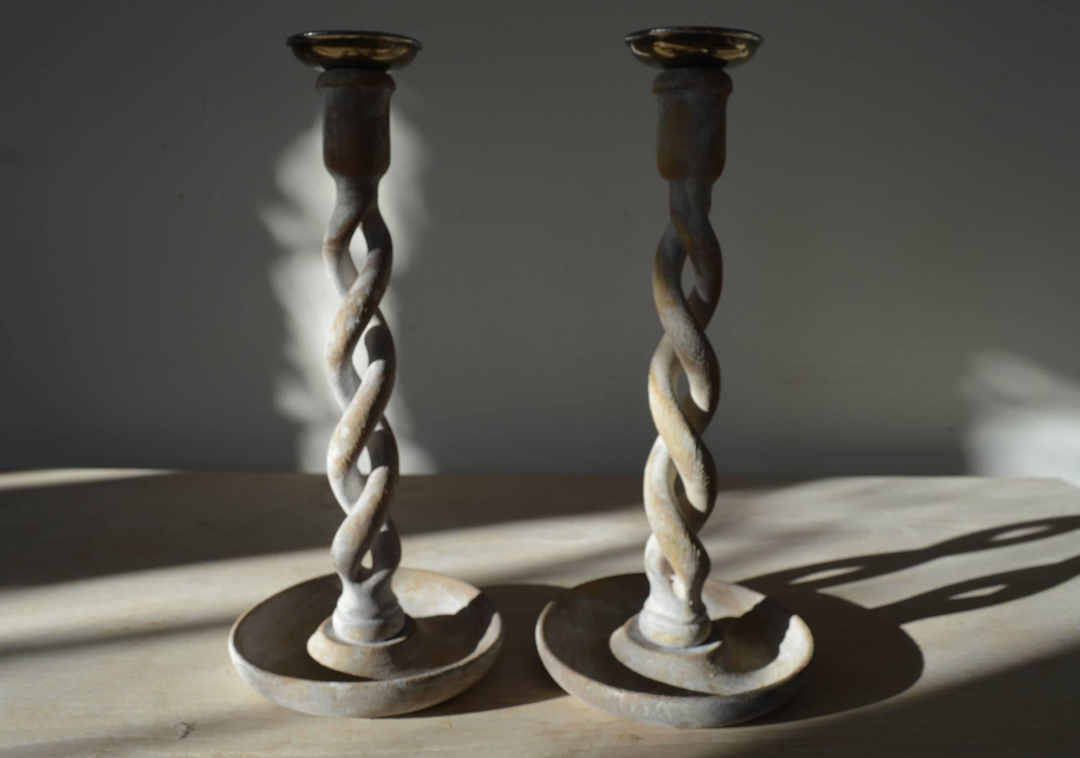 
A super pair of limed oak open twist candlesticks.

They have been recently limed to enhance the natural beauty in the wood.

The sconces are a made from pewter looking material and are original.

They can be easily converted to make table