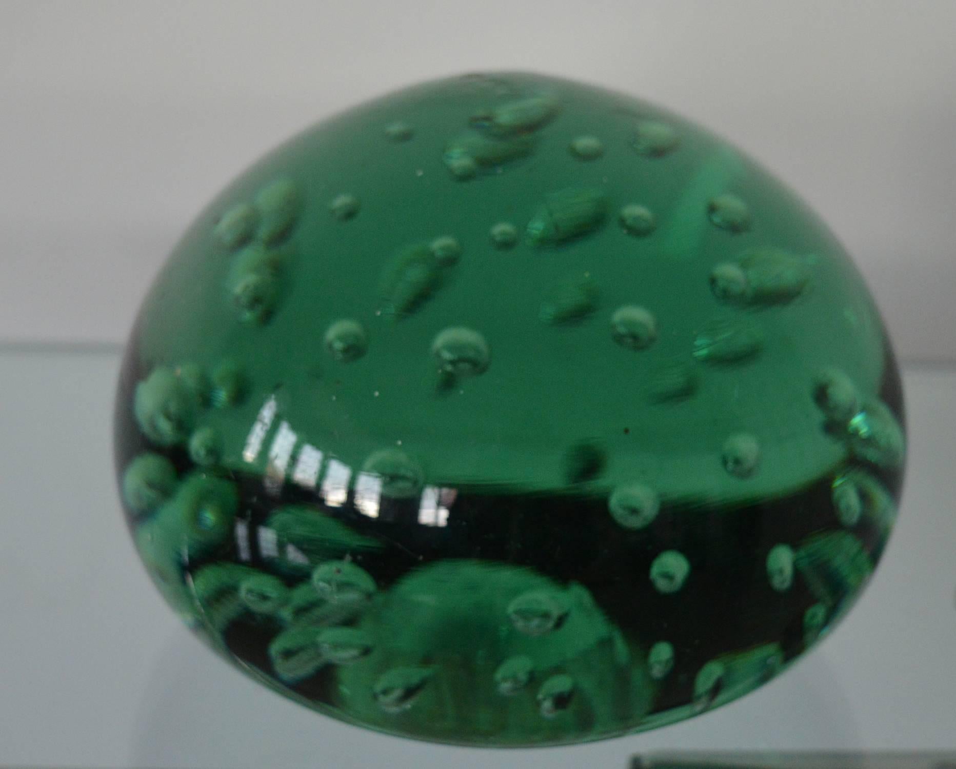 
Wonderful piece of green glass with a bubble effect interior.

These are commonly referred to as "dumps."

It can be used as a doorstop, paperweight or simply as a piece of sculpture.