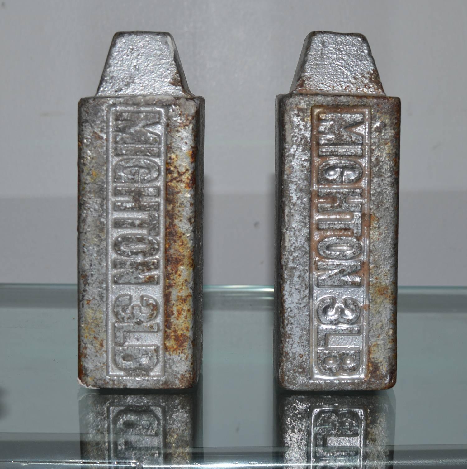 
A pair of Industrial style 3 pound weights that makes a great pair of bookends, letter rack, or paperweight.

Original paint on the cast iron.

Trademark of Mighton on one side of each of them.


