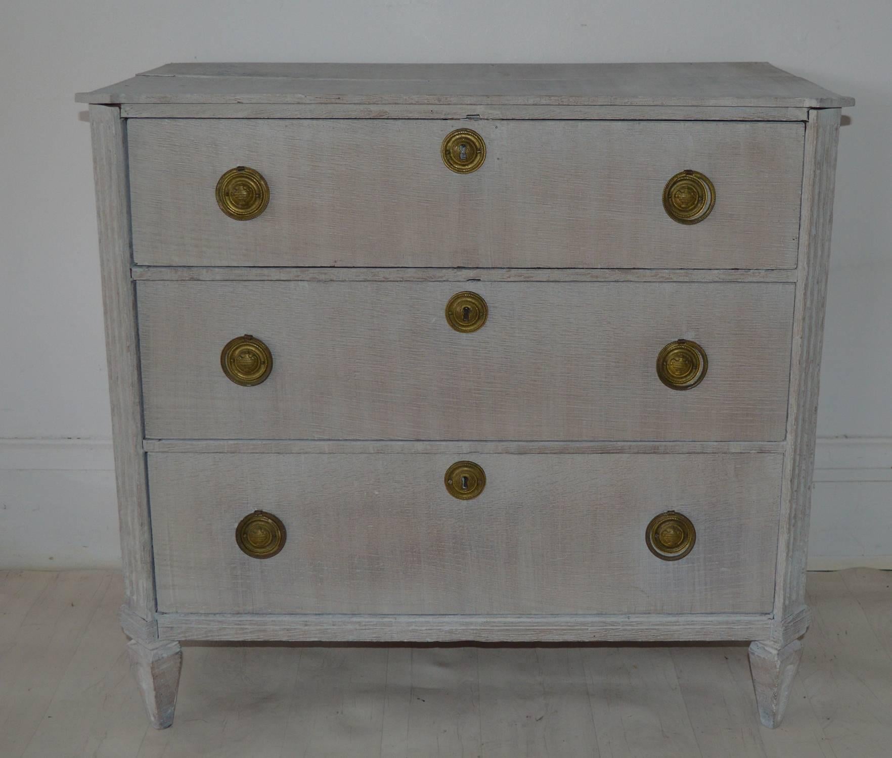 Charming limed oak commode or chest of drawers.

Provincial French in Directoire taste. 19th Century.

Wonderful simple lines. Fluted canted corners. Original almost triangular shaped feet.

The piece has been recently limed.

The gilt brass