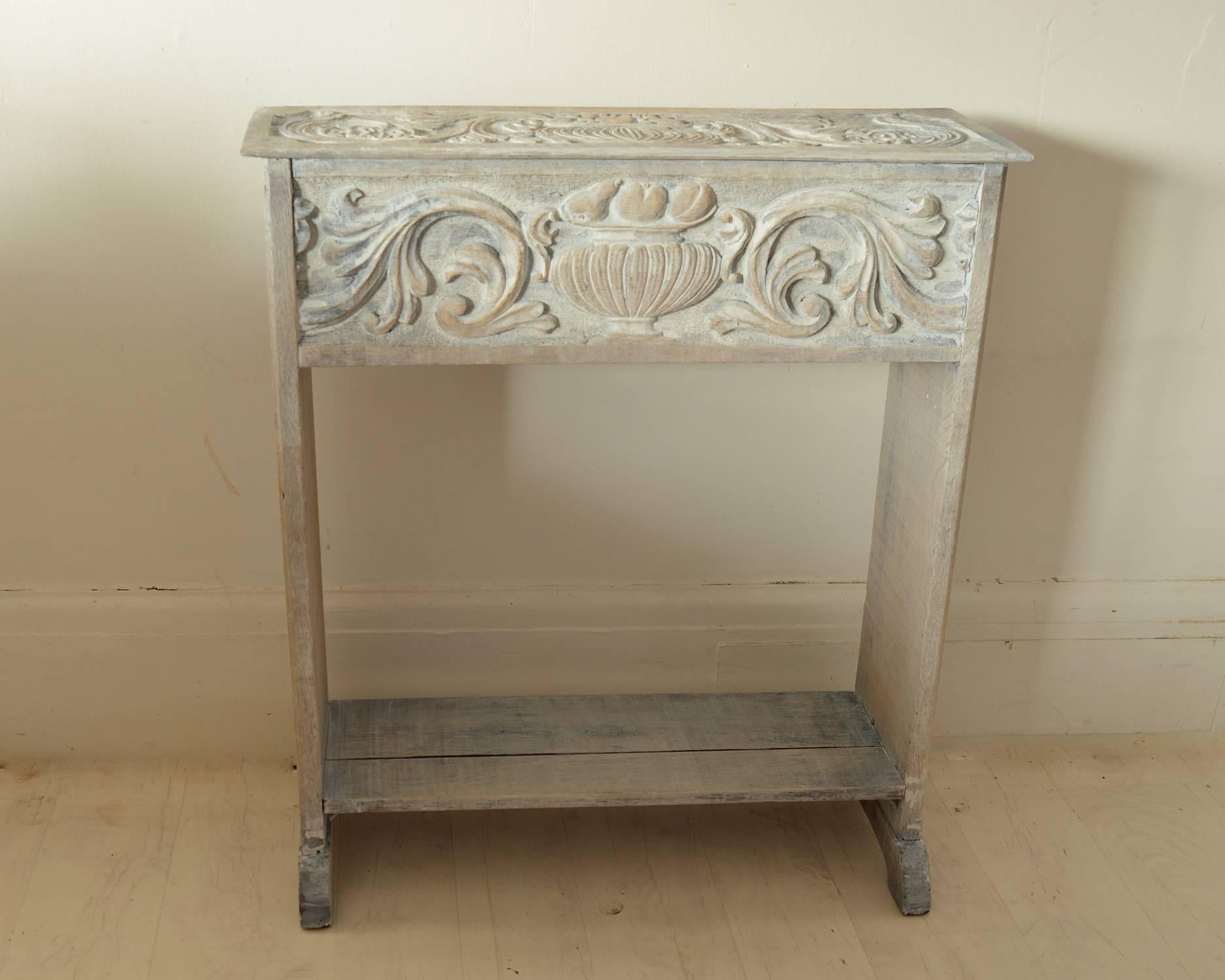 
Charming renaissance revival console or side table.

Beautifully carved to top front and sides.

The piece has been recently limed.