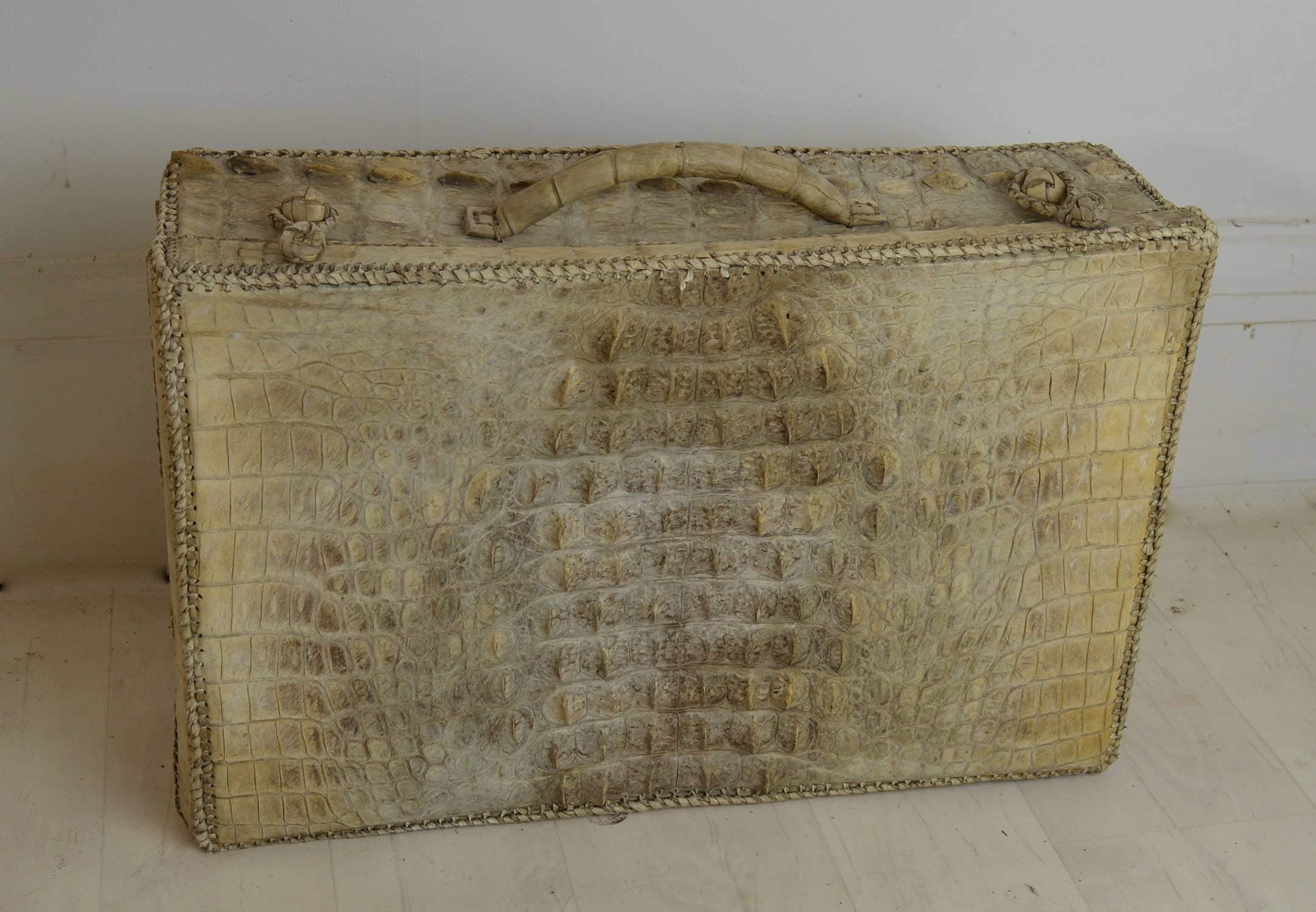 Beautiful white crocodile suitcase or vanity case.

Sensational color of off-white or cream.

Uncertain of the origin but it has a certain ethnicity about it. Probably handcrafted in India or Africa.

Sumptuous cream leather interior.
    