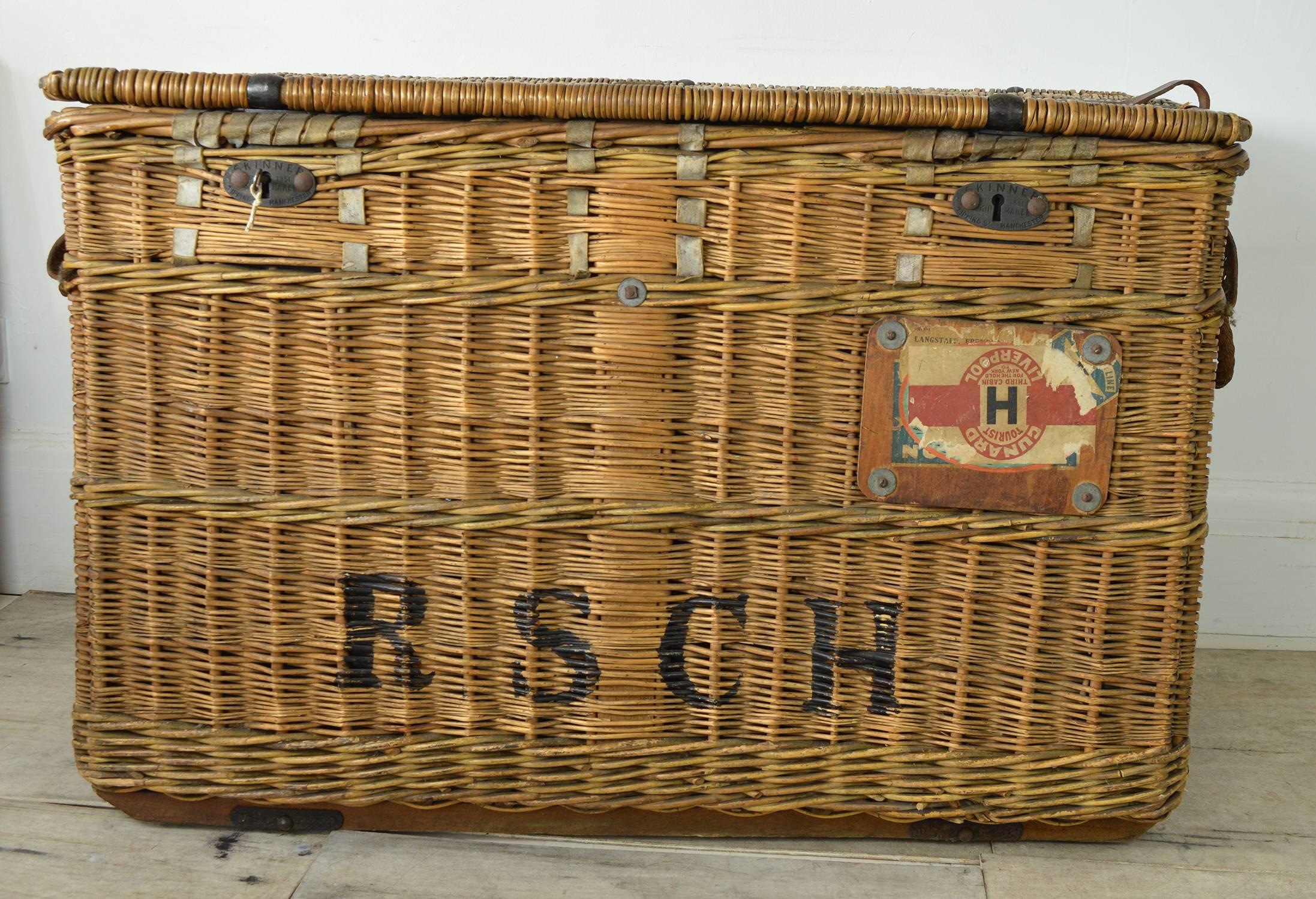 A fabulous wicker trunk of sufficient size as to make a piece of furniture console or buffet.

Wonderful color.

Great character and history. Exemplified by the Cunard label on it.

Lockable with the original key. Original canvas