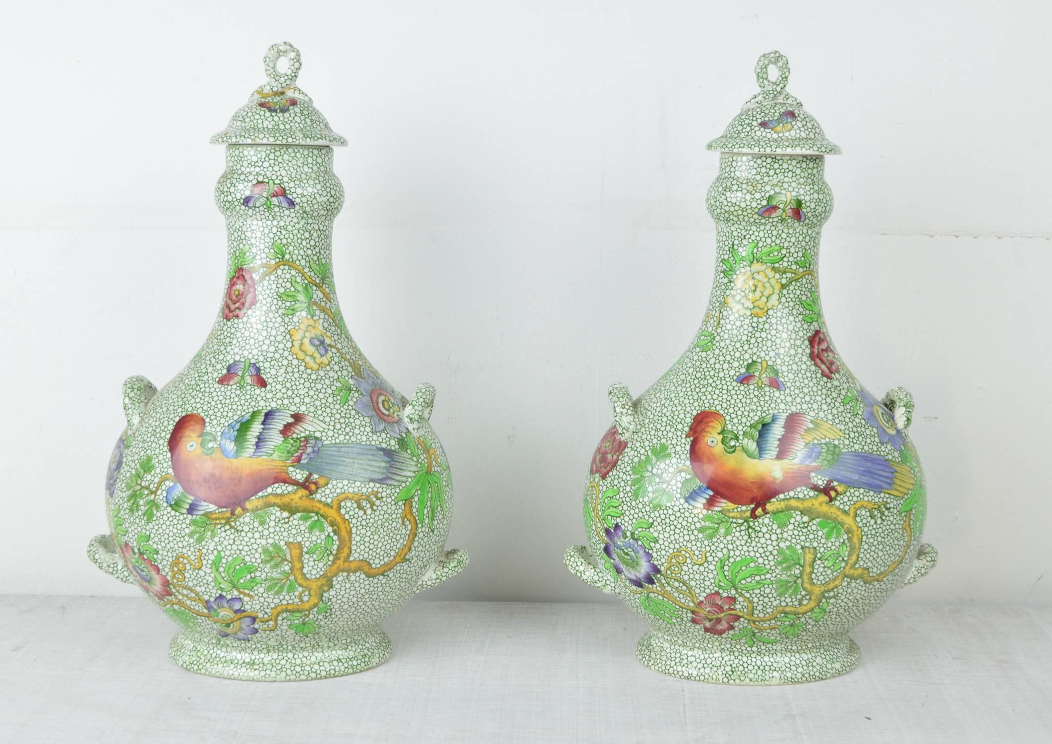 Fabulous pair of cover vases in a classic chintz pattern.

Transfer printed green background surmounted by wonderful exotic asiatic birds, flowers and butterflies.

Makers mark of Copeland Spode on the underside.

One of the finials has an old
