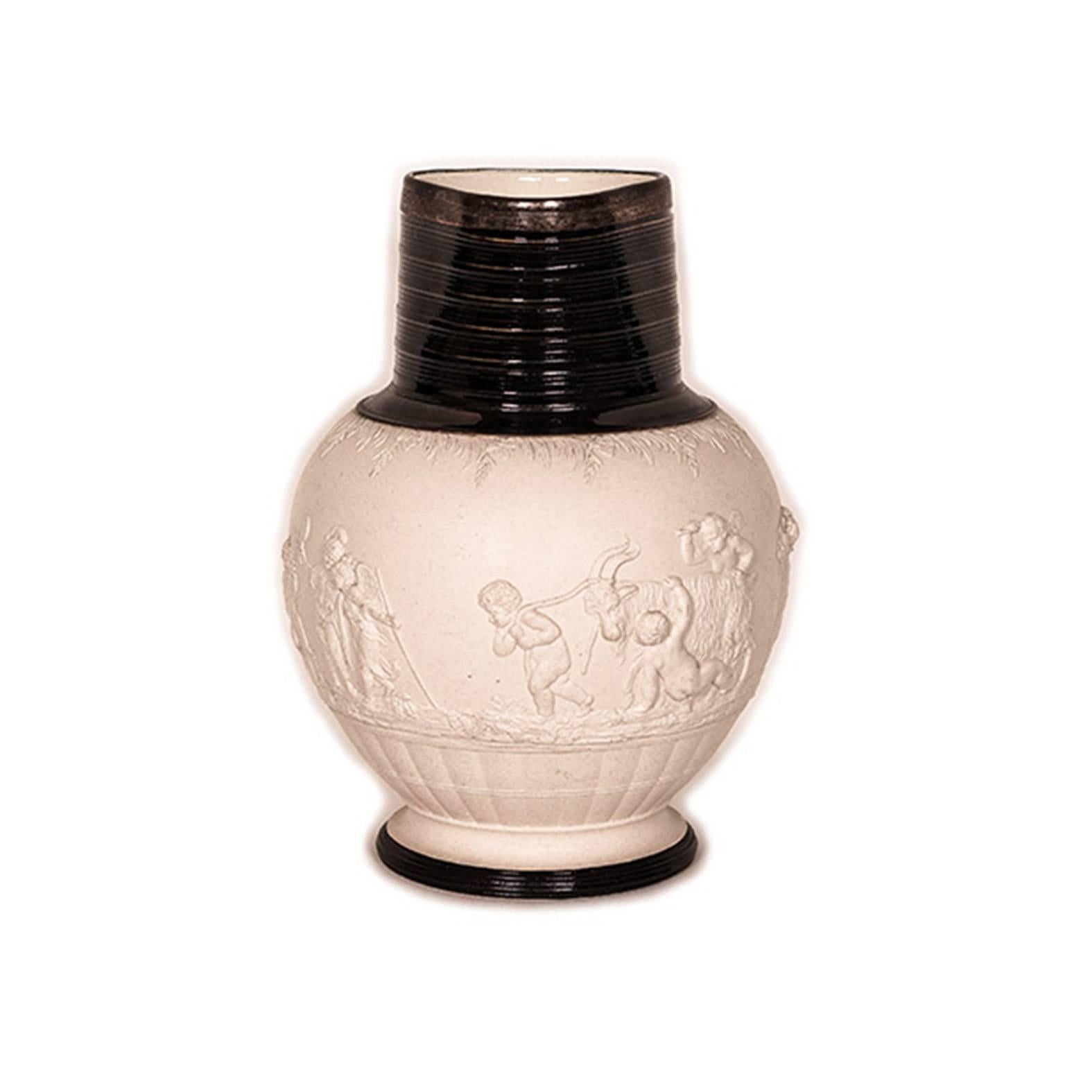 Modeled in relief with bacchanalian infant revelers reaping a grape harvest. With a ribbed and glazed neck and foot, a silver plated rim and an impressed Adams mark.