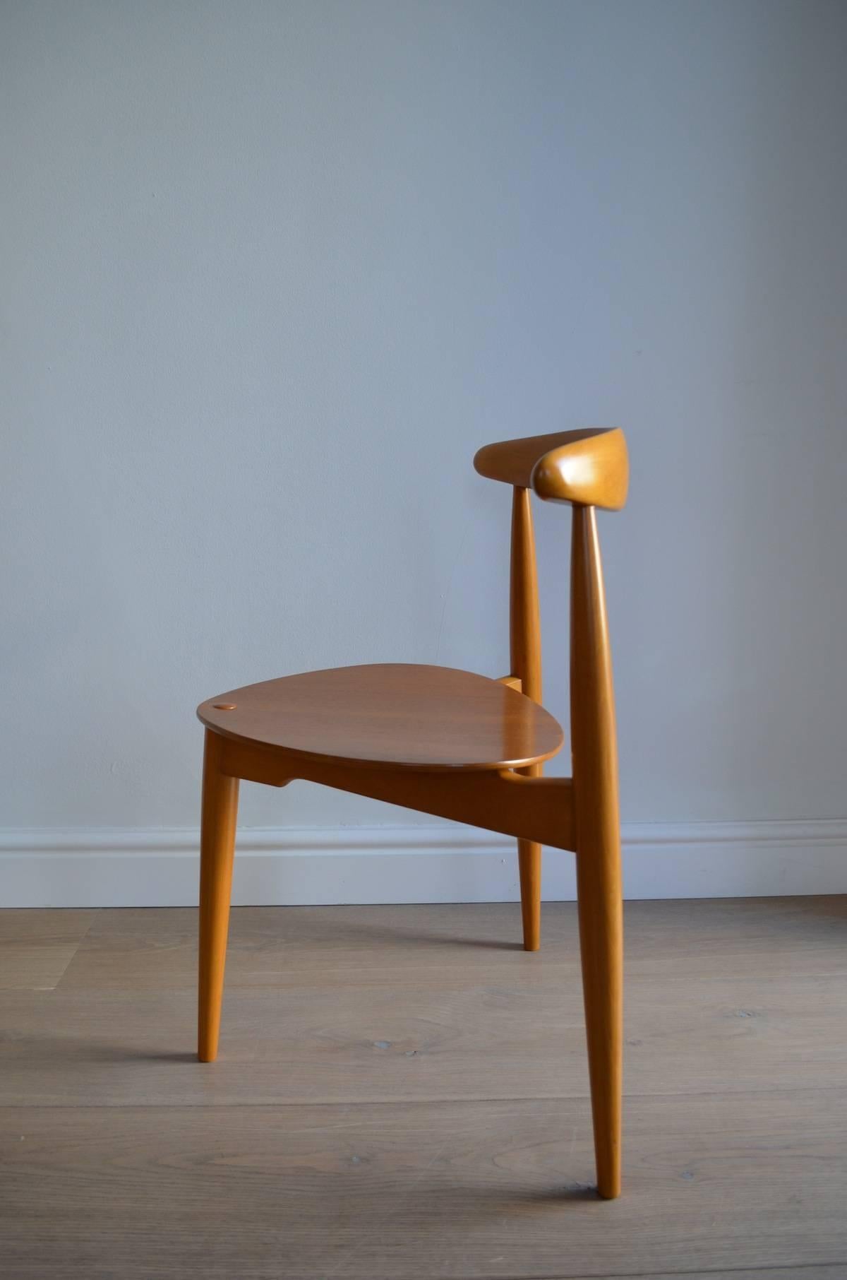 This iconic dining set was designed by Hans J. Wegner in the 1950s and produced by Fritz Hansen in Denmark. It consists of a three-legged table (Model FH4602) with six stackable ‘heart’ tripod chairs (Model FH4103).

Stamped with manufacturers FH.