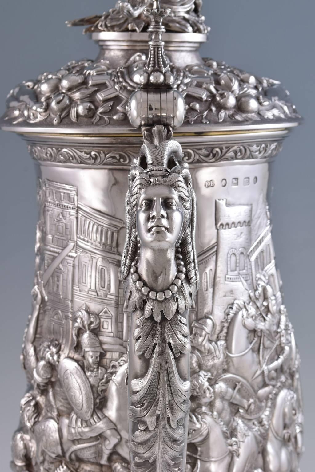 Hallmarked Elkington & Co. Birmingham, 1861.
 
Measures: 25 1/2 inches (65cm) high.
235oz (7.3kg)
 
Profusely decorated in high relief with scenes depicting a great Greek battle. Most likely Alexander's victory at Thebes (335 B.C.) The hinged
