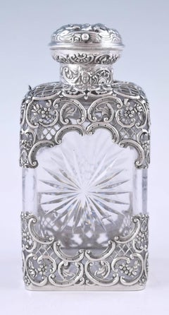 Three Edwardian Silver Mounted Glass Perfume Bottles