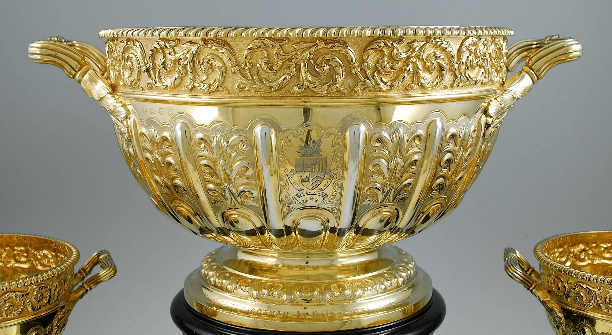 J. B. Carrington London & Birmingham, 1893.

With contemporary engraved crests and presentation inscription to the foot of the large bowl.

In original fitted wooden box.

Large bowl: 12 1/2 inches (32cm) high on plinth, 17 inches (43cm) over