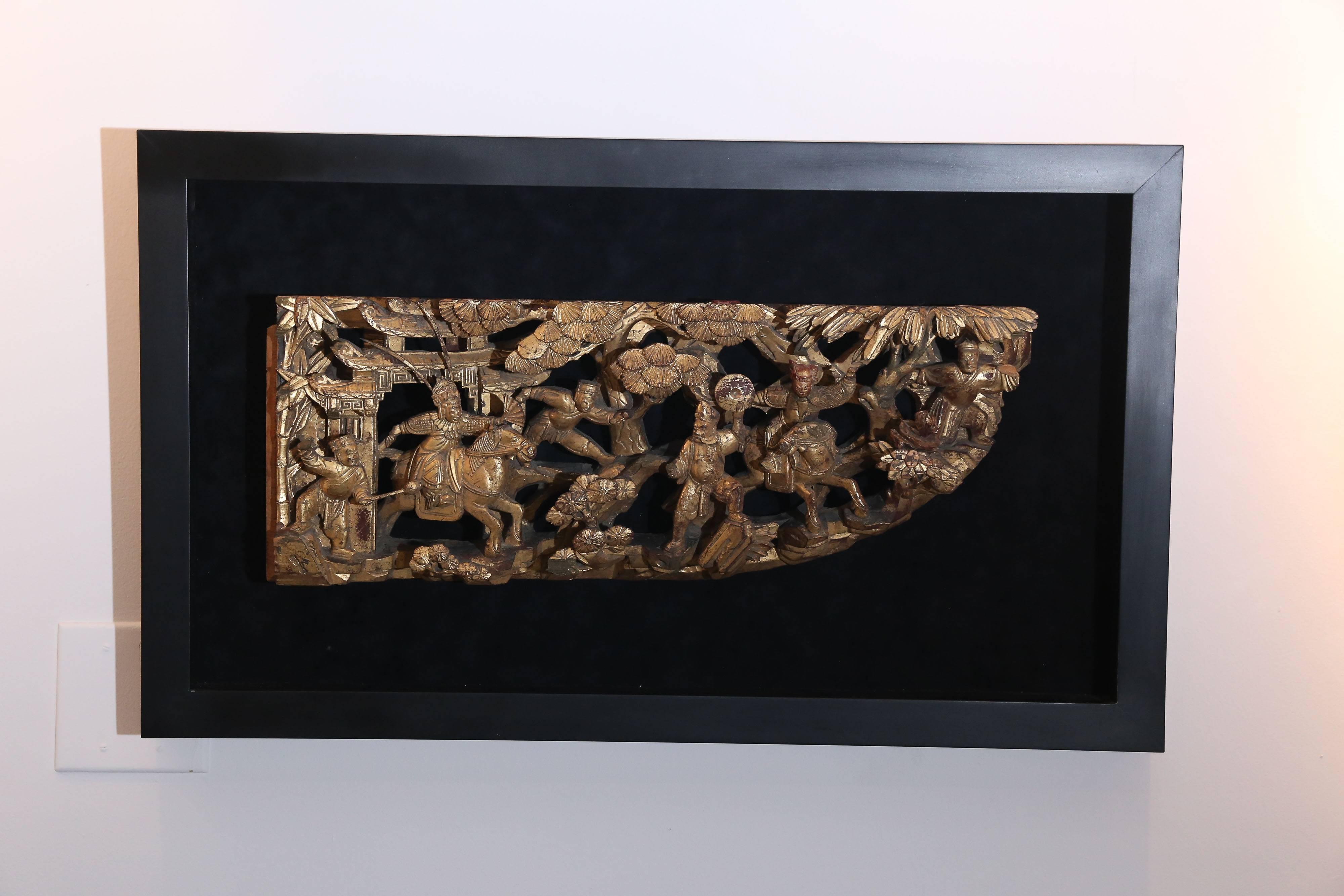 This is a Chinese 19th century architectural fragment, possibly from an elaborate bed or a door frame. Intricately hand-carved, late 19th-early 20th century temple piece suggests faraway places in a different time. In this corner piece appear men in