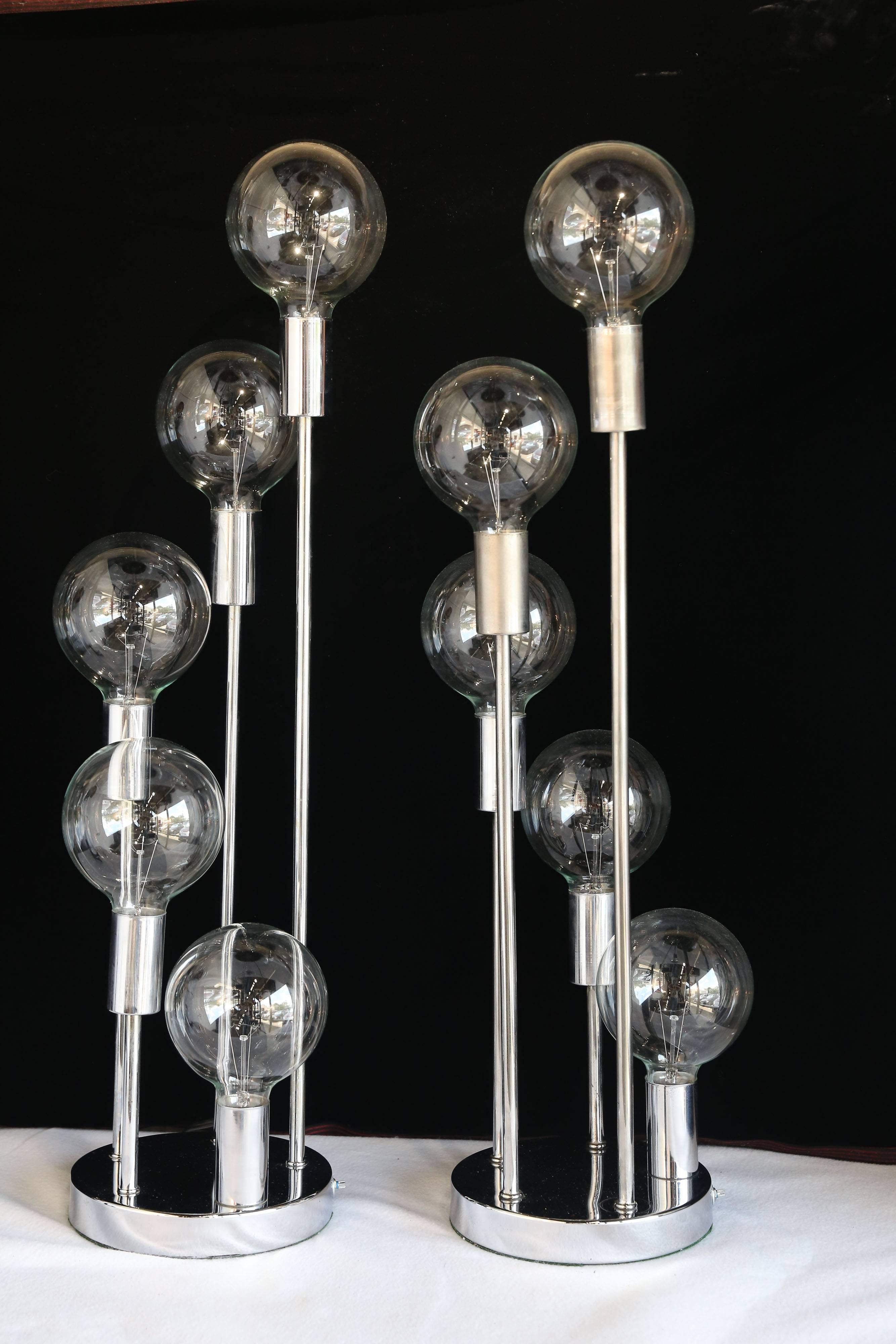 Perfect Mid-Century Modern chrome table lamps attributed to J. T. Kalmar. The lamps include five sockets (ball lamp shades of clear glass) spiraling in height to create a graceful curve. Signifying the future and the Atomic Age this lamp is most
