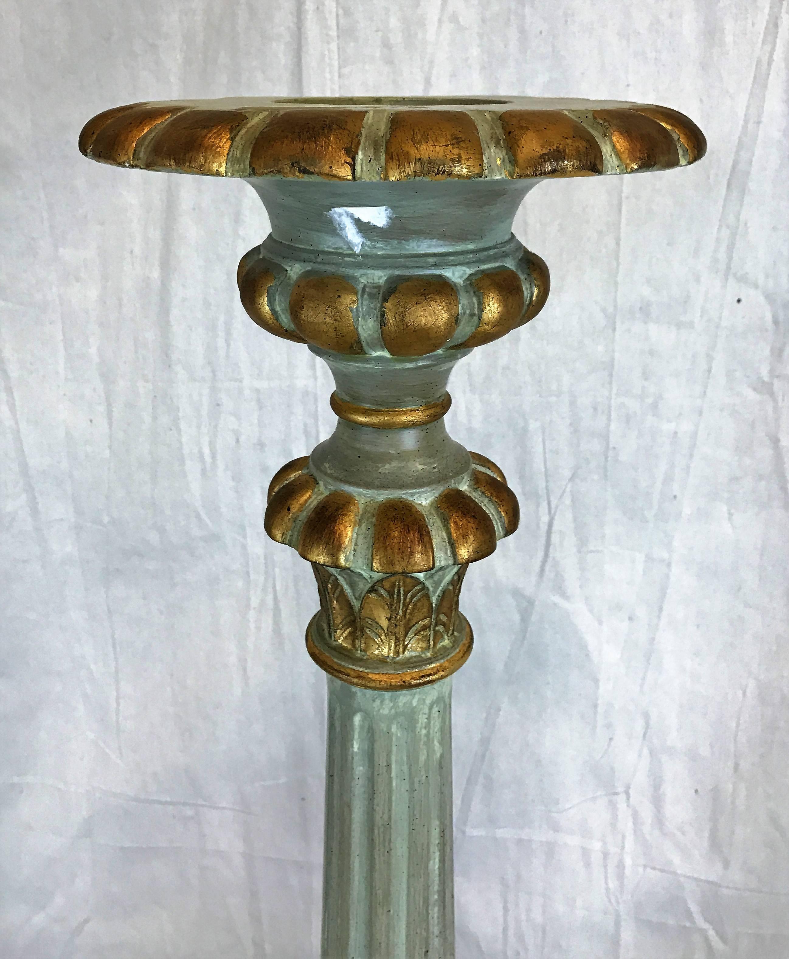 Lovely blue and gold carved 1970s, Italian candlesticks that would be lovely transformed into lighted lamps. Exquisite cherub faces grace the bottom between the cabriolet legs and claw feet. The diameter of the candle stick at the top is 10".