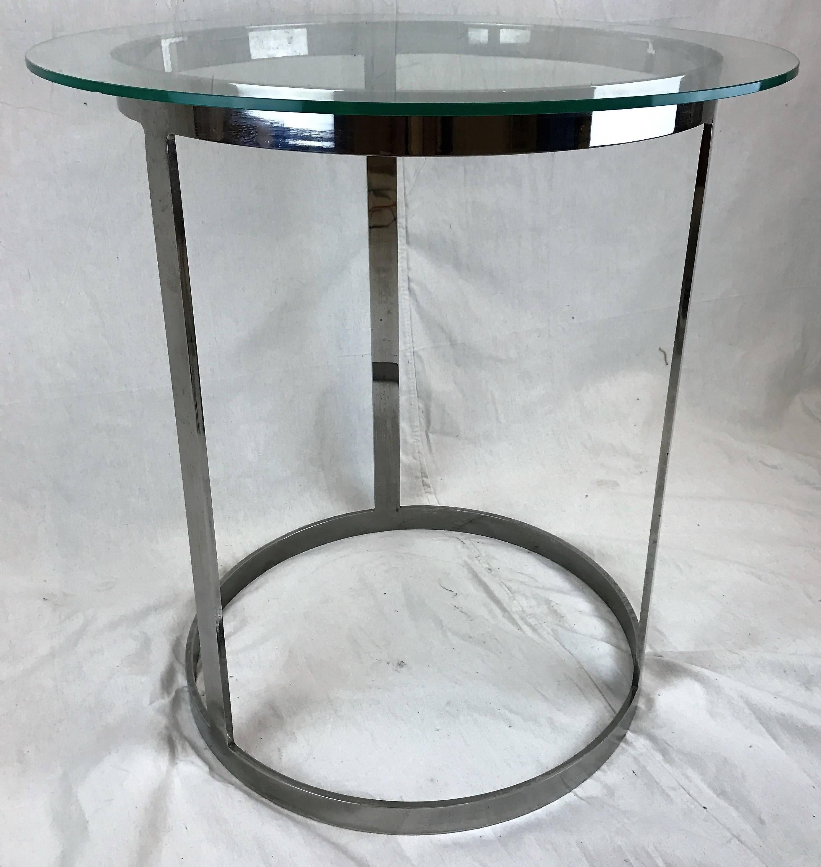 Stunning round glass and chrome occasional table designed by Milo Baughman. Constructed of a highly polished chrome tubular frame with 3/8 inch; removable glass top.
