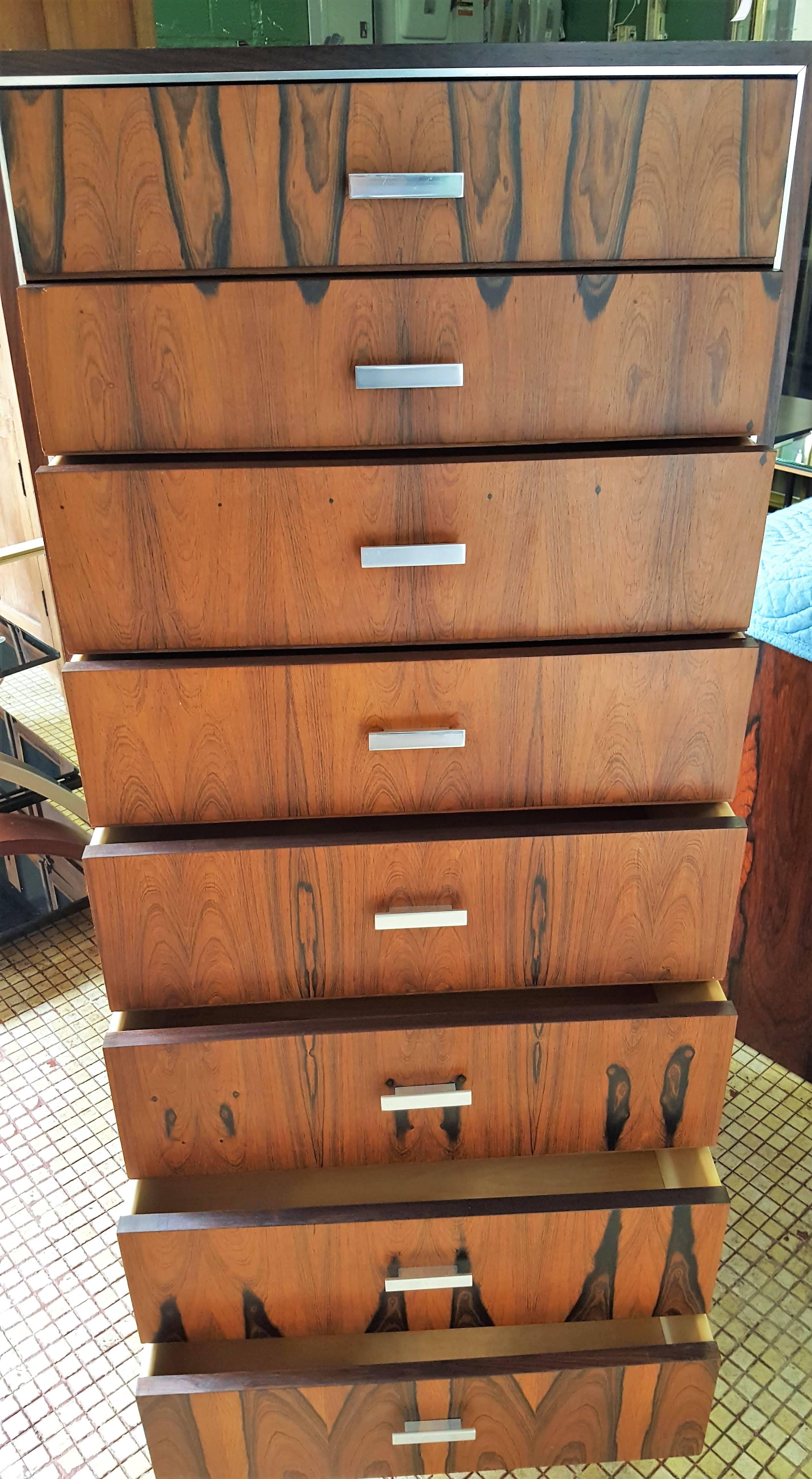 Gorgeous tall chest that is part of a collection sold separately. The rosewood pattern is spectacularly connected at all heights and sides of this dramatic piece. Eight drawers graced with chrome pulls are finished on the inside with pine. Lovely