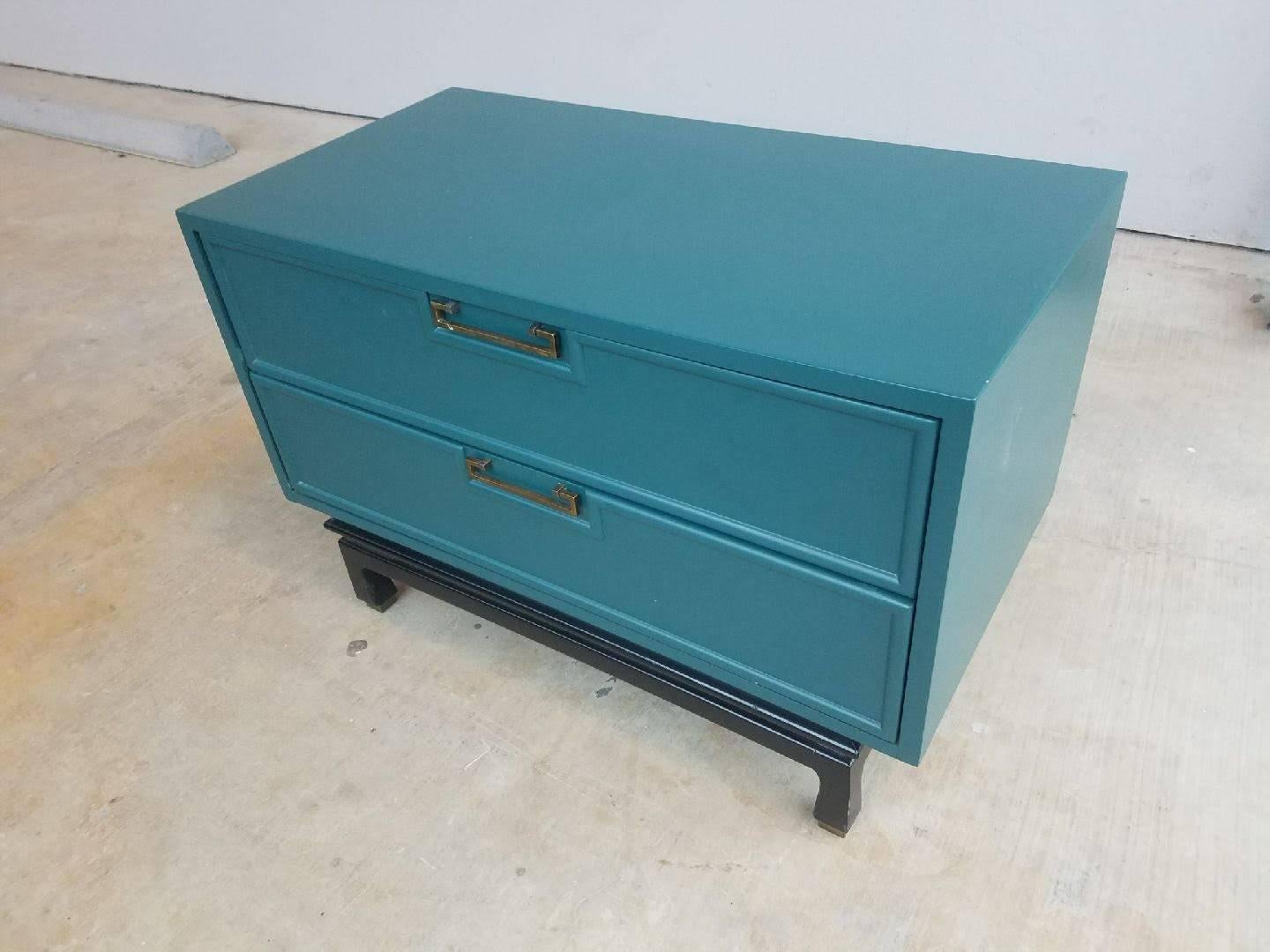 Lovely pair Mid-Century Modern two-drawer nightstands lacquered in peacock blue over walnut, showcase the clean lines attributed to American of Martinsville quality furniture designs. Sometimes labelled as Danish Modern this piece with an Asian