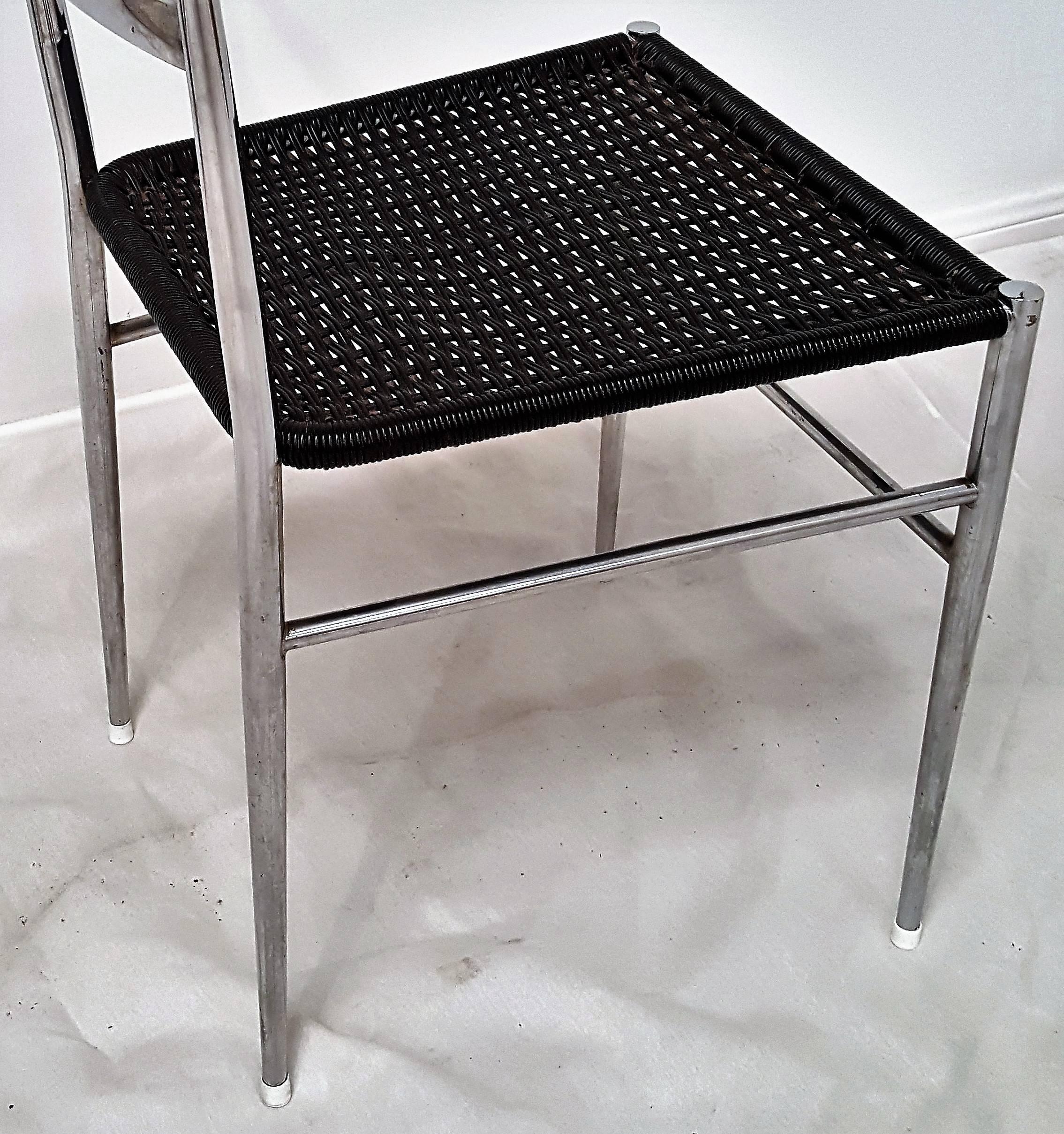 Pair Gio Ponti chrome frame Leggera dining chairs with black vinyl wire woven seats.