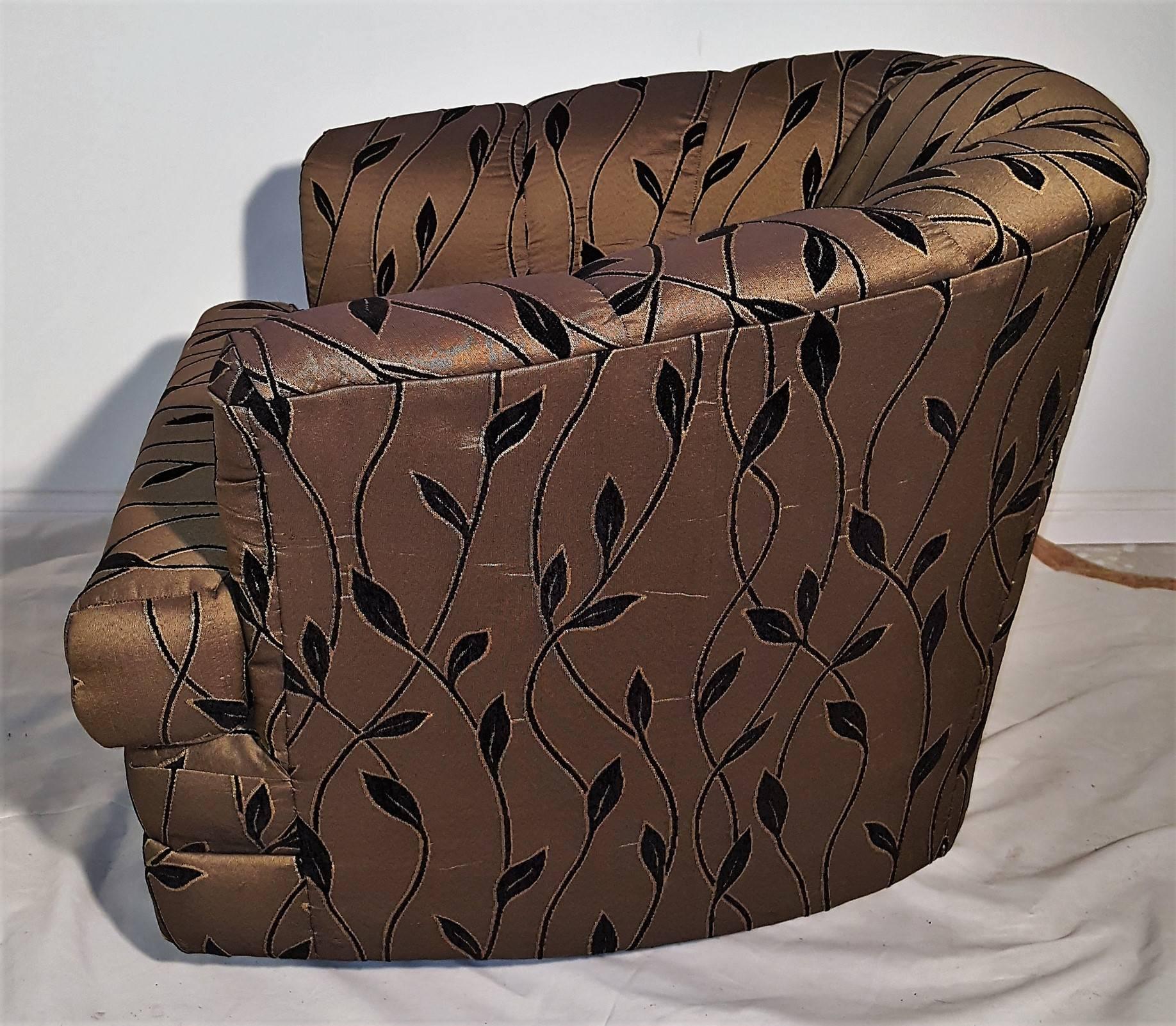 Pair swivel barrel chairs attributed to Milo Baughman. Comfort level enhanced by the Classic channel back, t-cushion and rounded arms. Covered in a tan cotton fabric with vines leaves. Perfect!
