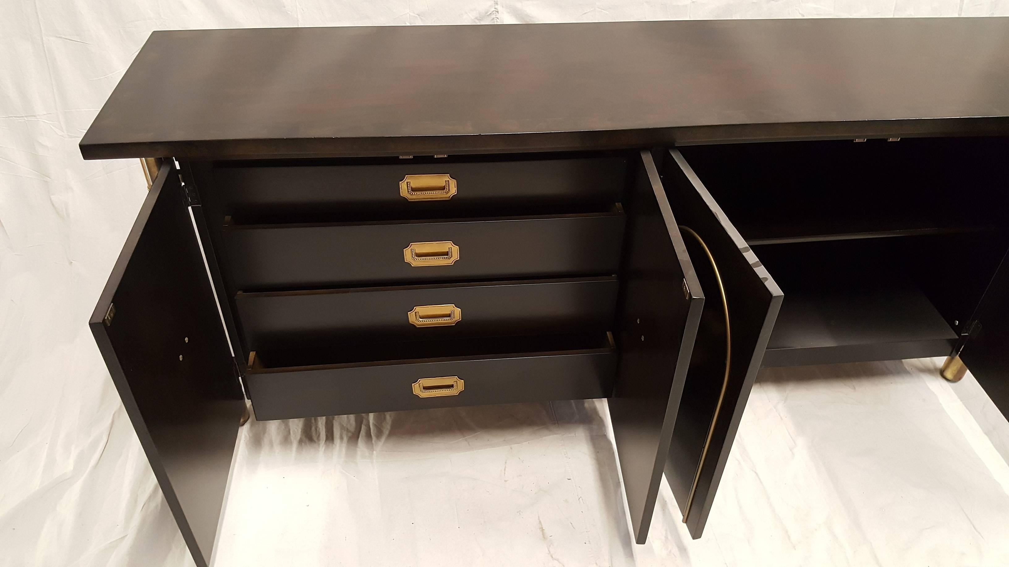 Mastercraft buffet with Amboyna wood with brass legs and hardware. Inside of cabinet doors are four draws. The top has a burl trim around the edge.