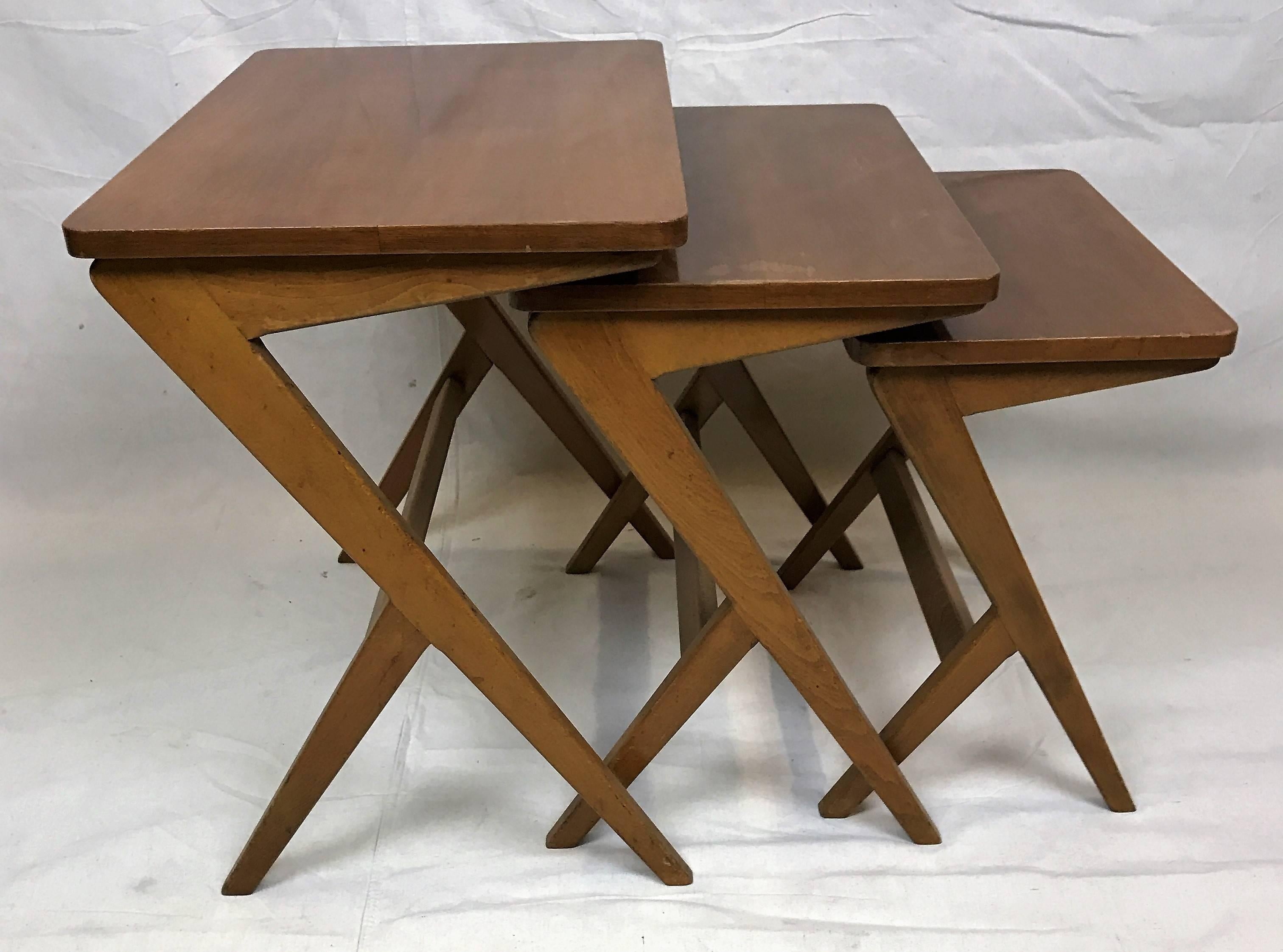 Lovely teak nesting tables attributed to Ico Parisi. Mid table is 18in H x 18.5in W x 12in D and the smallest table is 16in H x 16in W x 10in D.