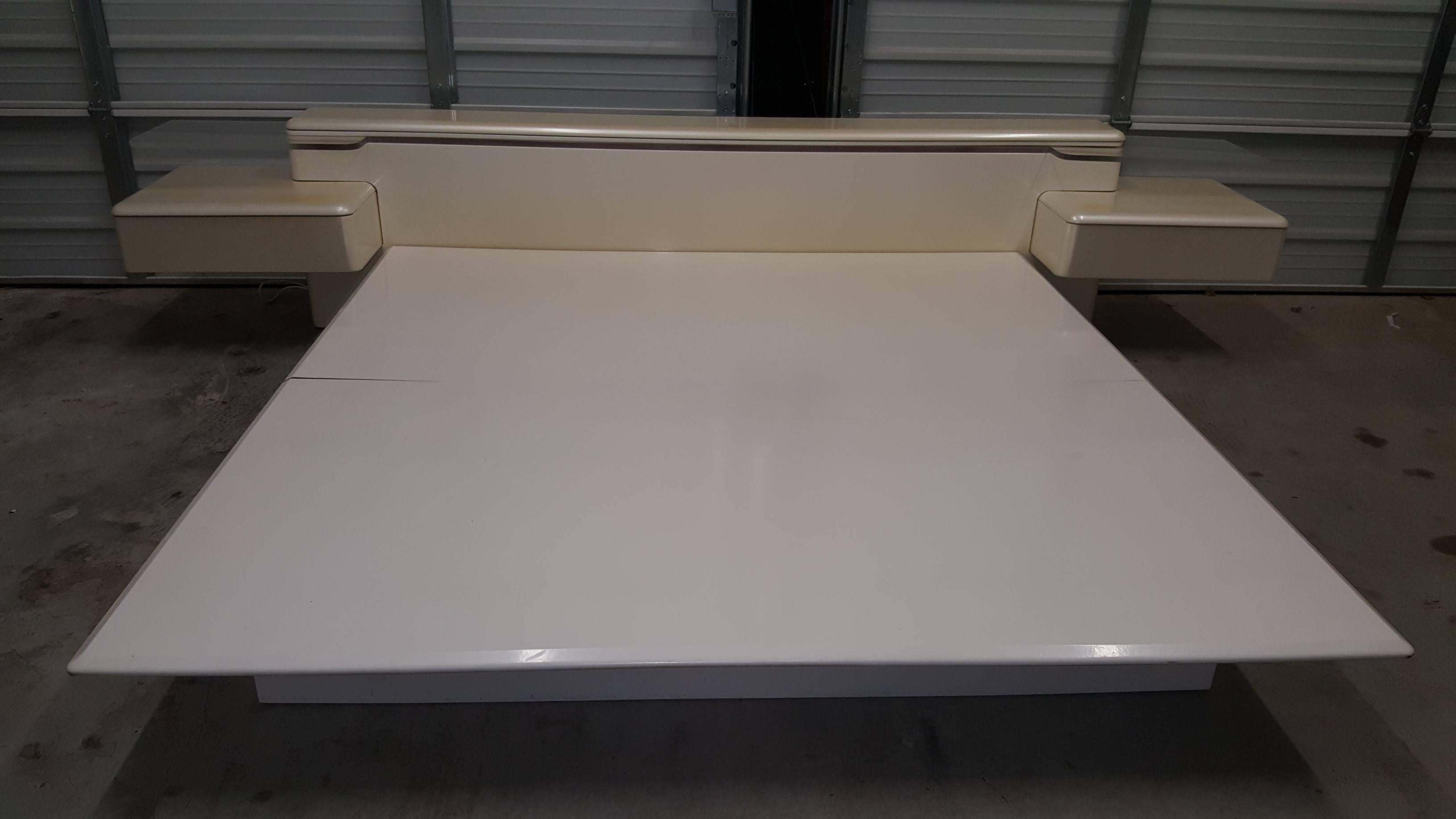 1970s Rougier platform bed with Lucite shelves, lighted headboard and floating nightstands with drawers. Some slight stains on night stands (left and right).  The bed is complete.  I previously mentioned that the lucite wings were missing, The bed