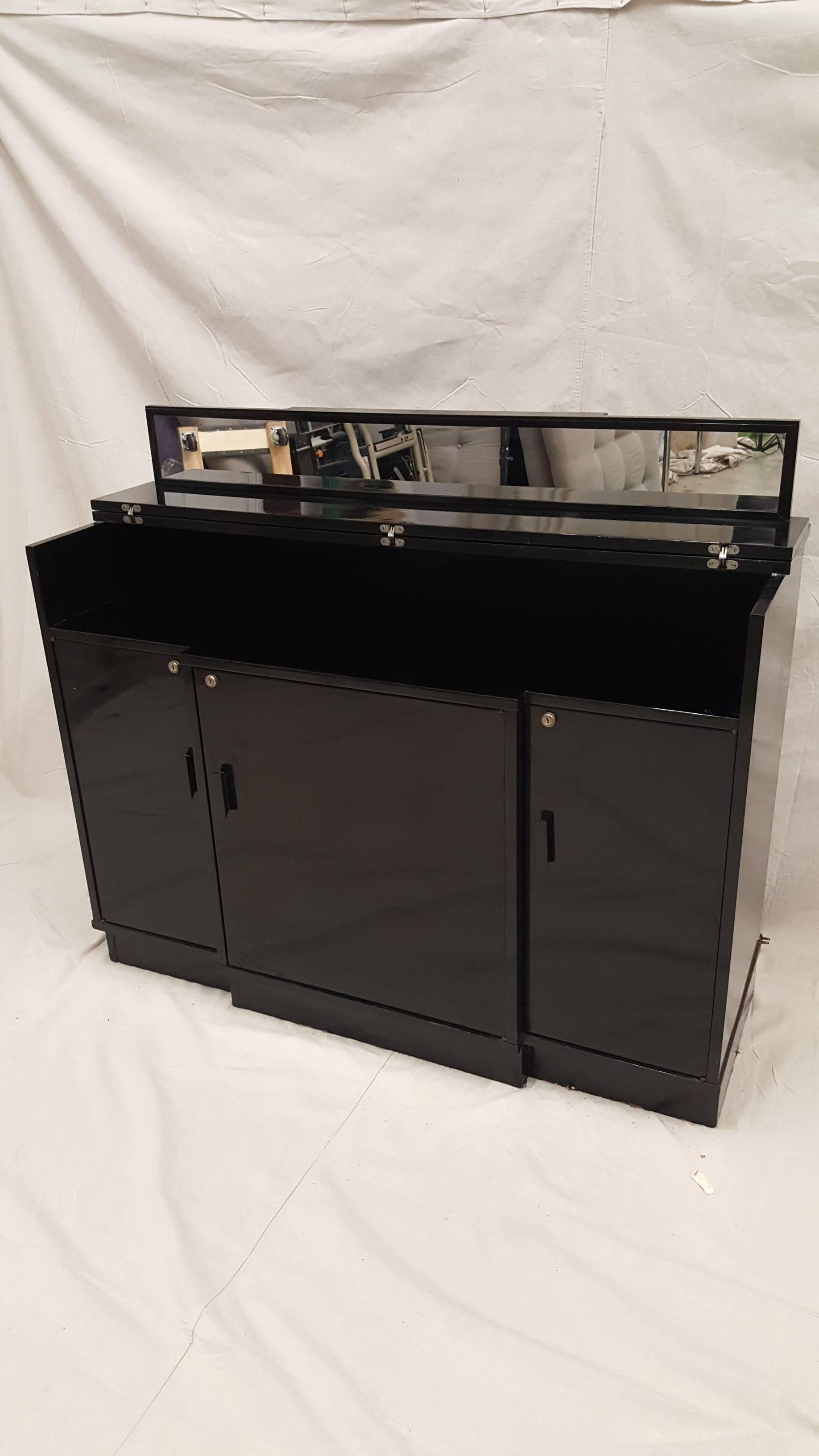 Extremely rare 1950s custom-made mini bar and cabinet, built in refrigerator and mini freezer. Rosewood veneer, lacquered with black enamel finish.  The refrigerator is still in working condition.  No keys come with the cabinet.