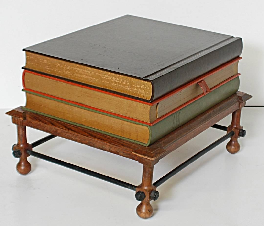 Rare stacked books table designed by John Dickinson and manufactured by Drexel. The middle book has a drawer which is opened by pulling on the 