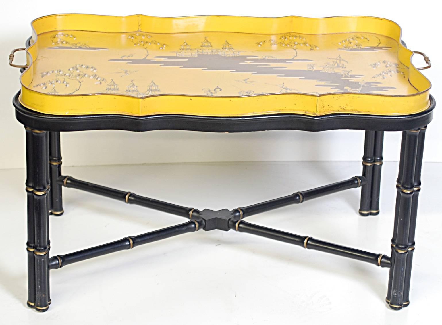 Yellow Chinoiserie decor lacquered tole tray resting on an ebonized faux bamboo base. The bottom of the tray is marked 