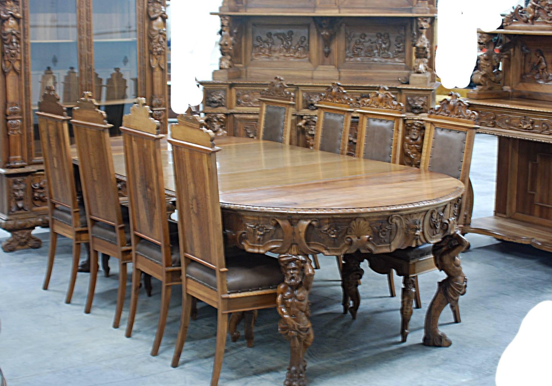 This incredible carved walnut dining room set includes:

Two-door china cabinet with figural maidens, cherubs and North wind face. 24.5