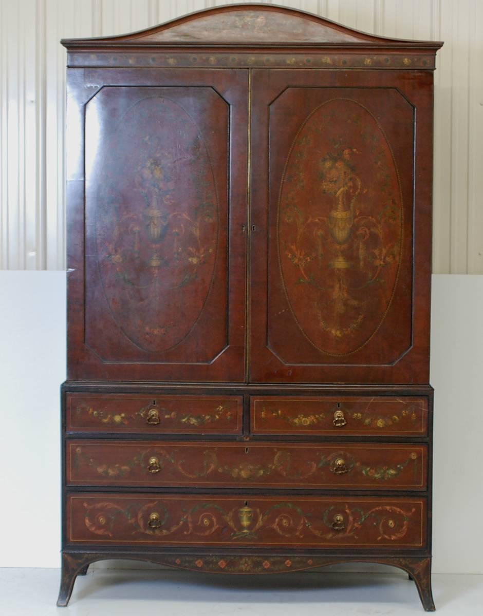 Antique English linen press with intricate painted floral design. The two doors, which are over four drawers, open to reveal six additional drawers.