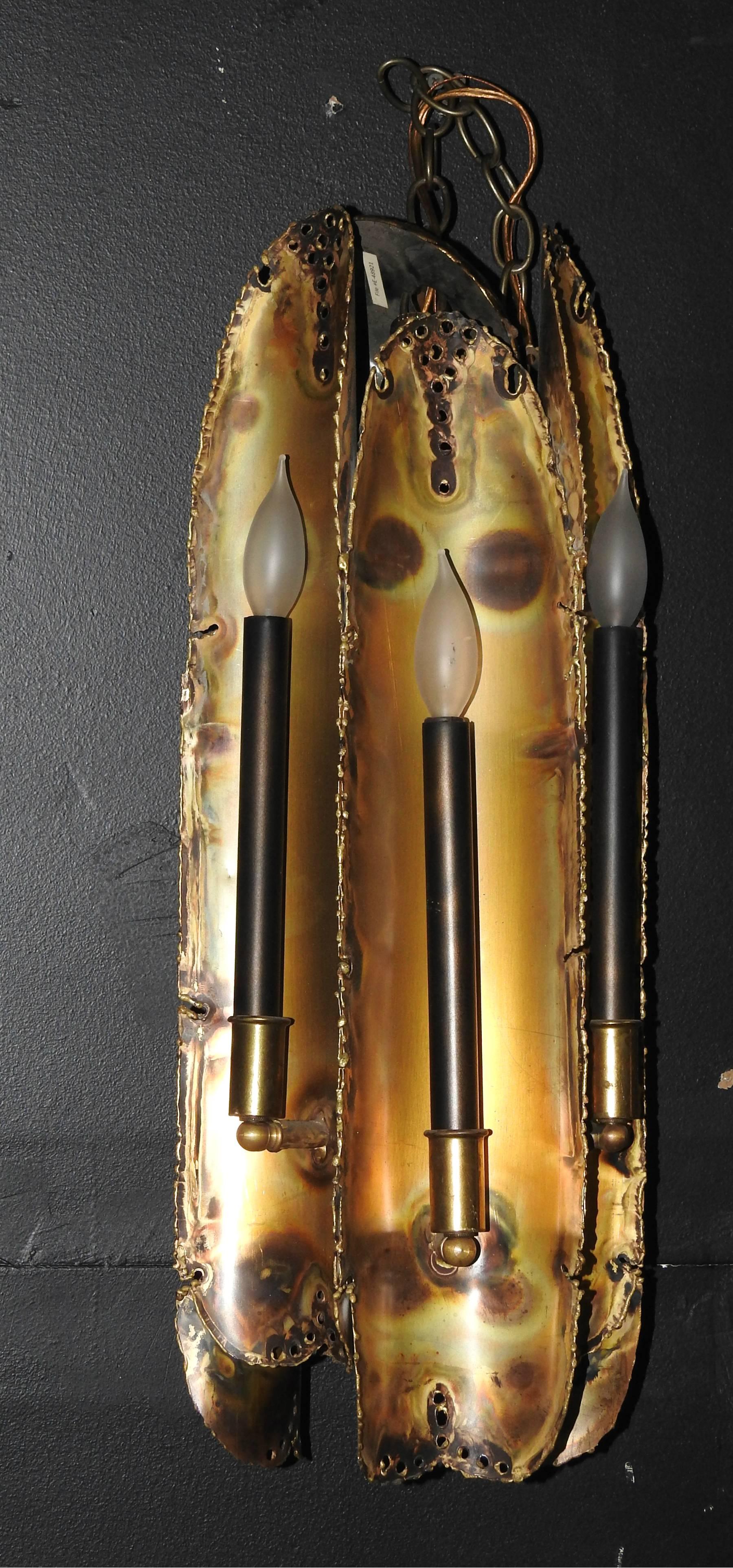 Six-light Brutalist torch cut brass hanging pendant light / chandelier by Tom Greene for Feldman Lighting.