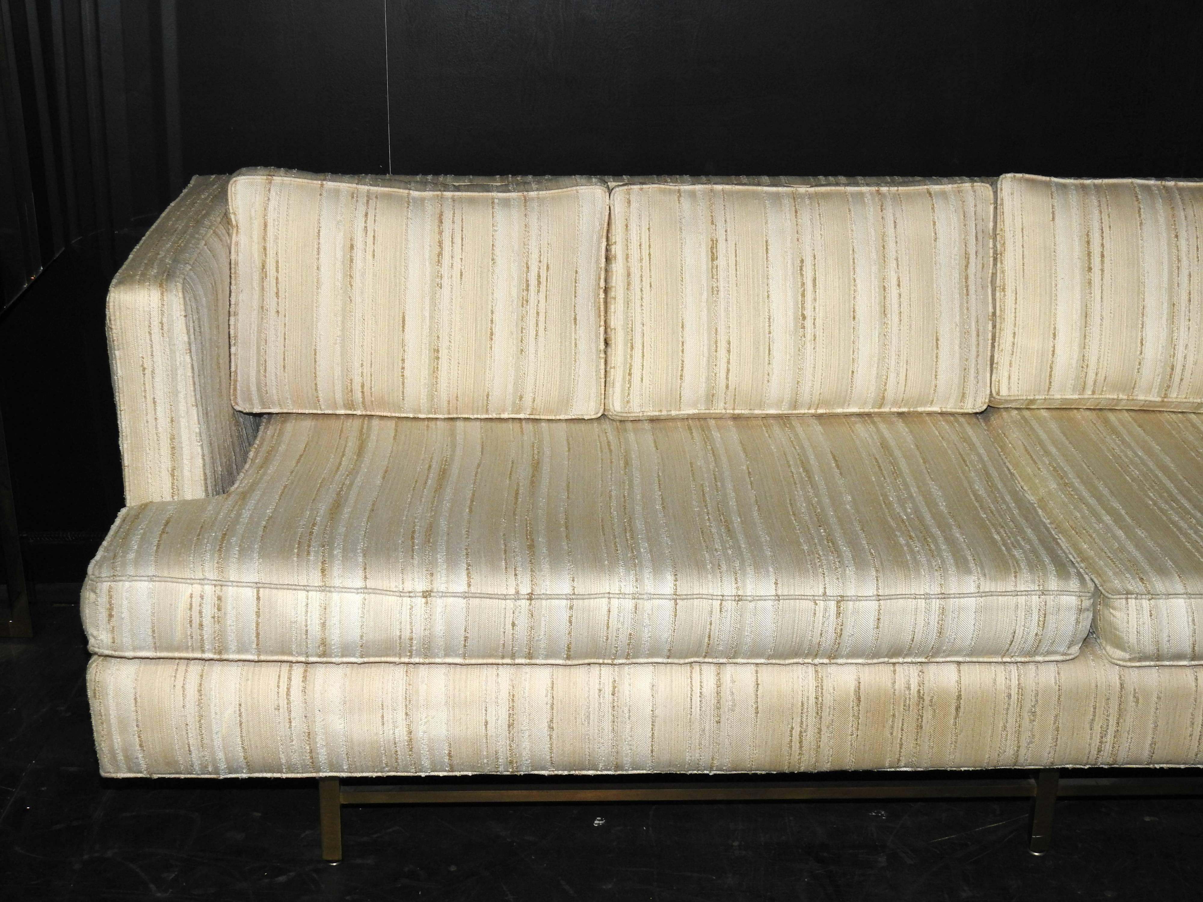 This outstanding Mid-Century Modern couch / sofa by John Stuart with four removable back cushions and two removable main cushions sits on a brass base.

This couch was procured from the original purchaser and has been re-upholstered since