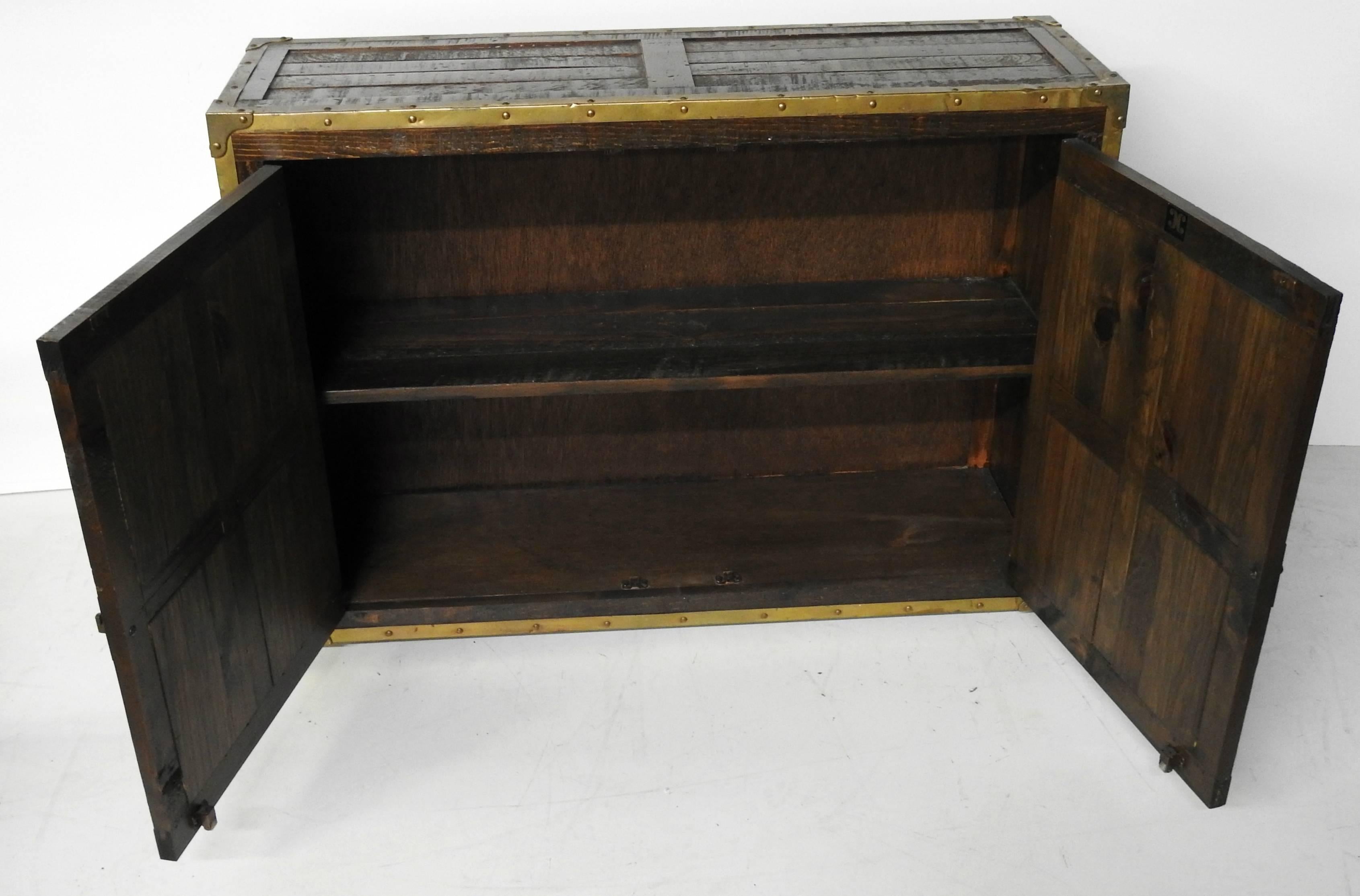 Habersham Campaign chest made of reconstituted wood with bronze trim and handles.