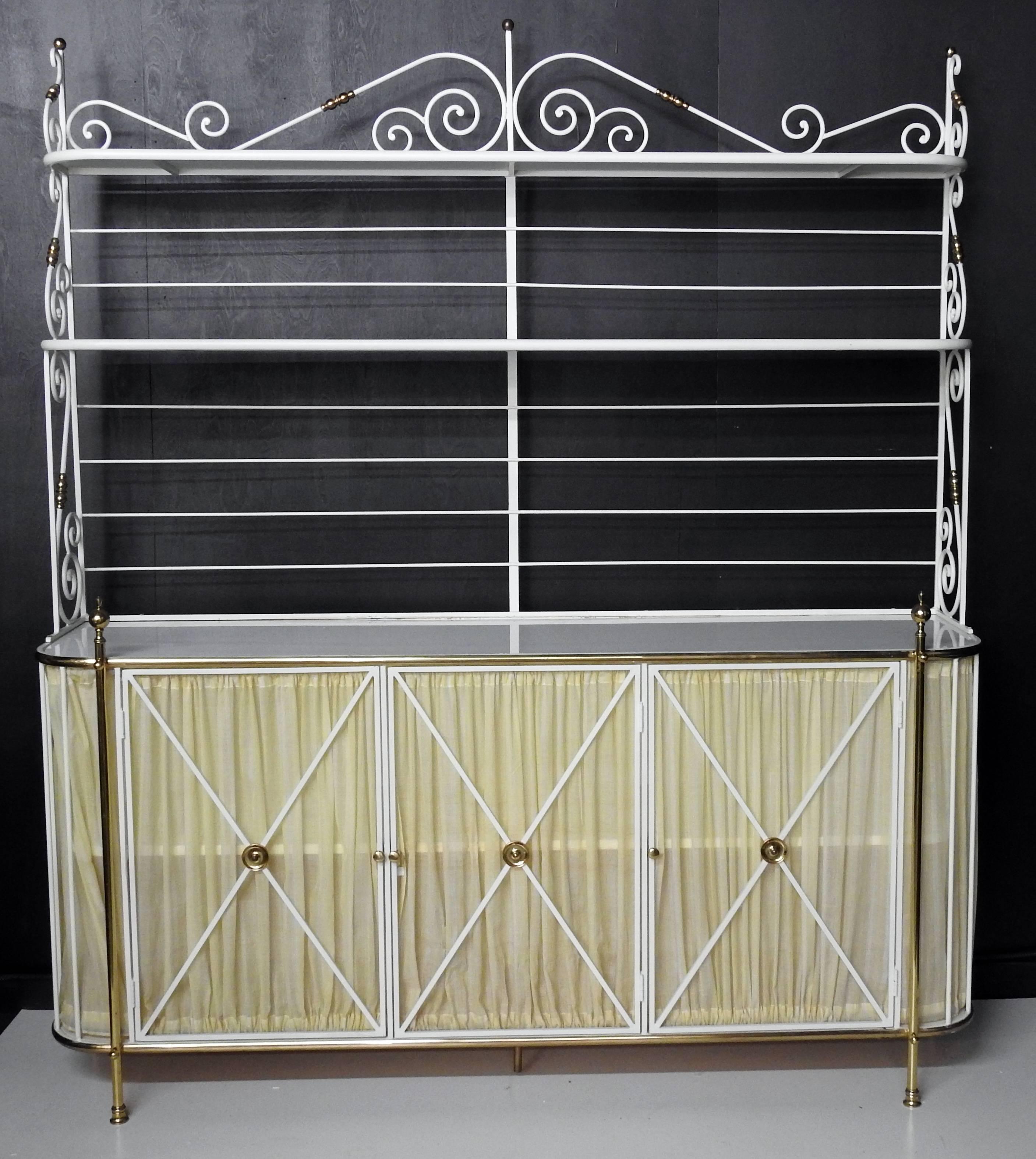Large French bakers rack or sideboard. Iron with three milk glass shelves, brass accents, and curtained doors.