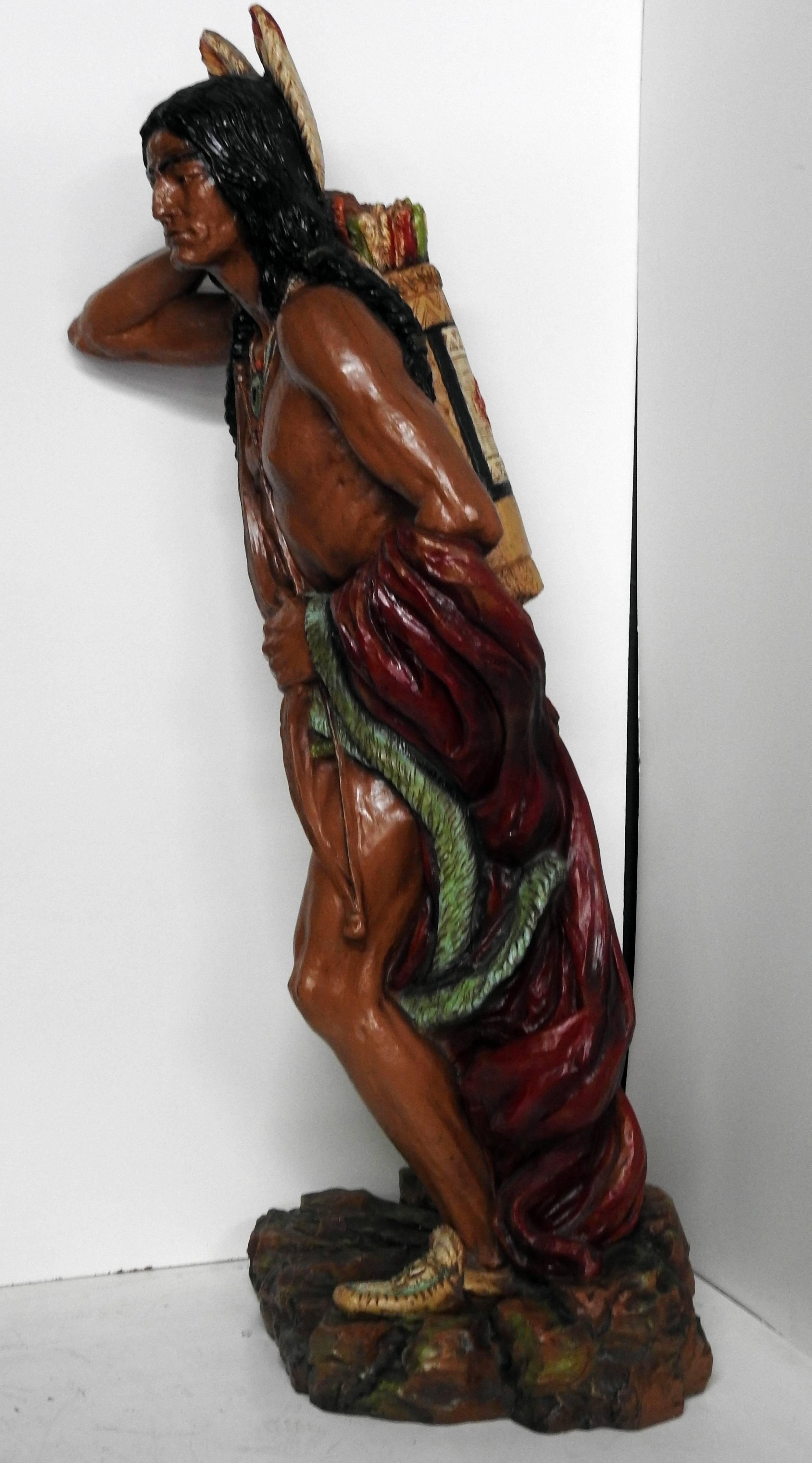 Fiberglass cigar store Indian sculpture with a weighted base.