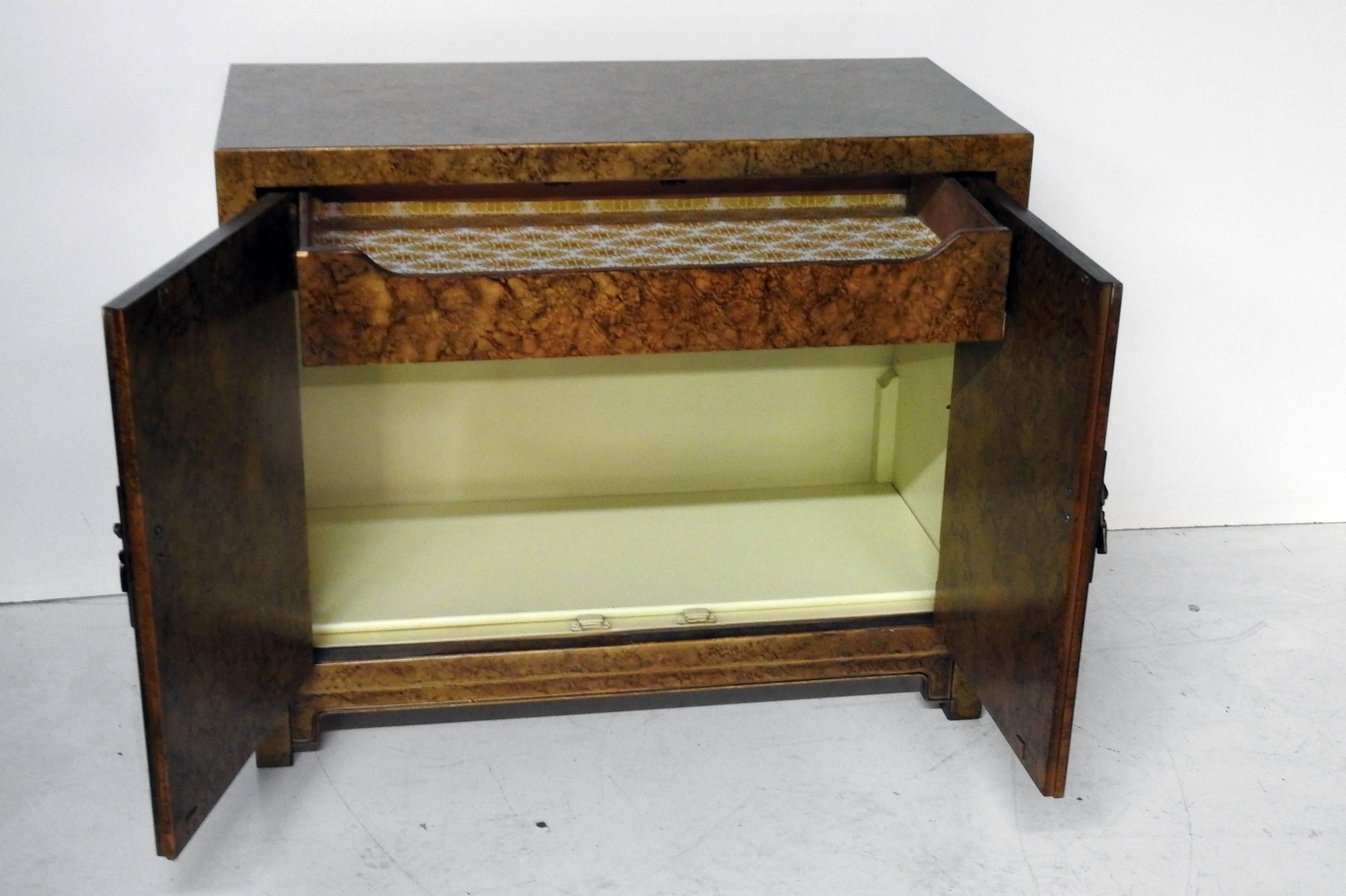 Vintage Henredon cabinet containing one drawer and one shelf with a faux tortoise shell veneer.