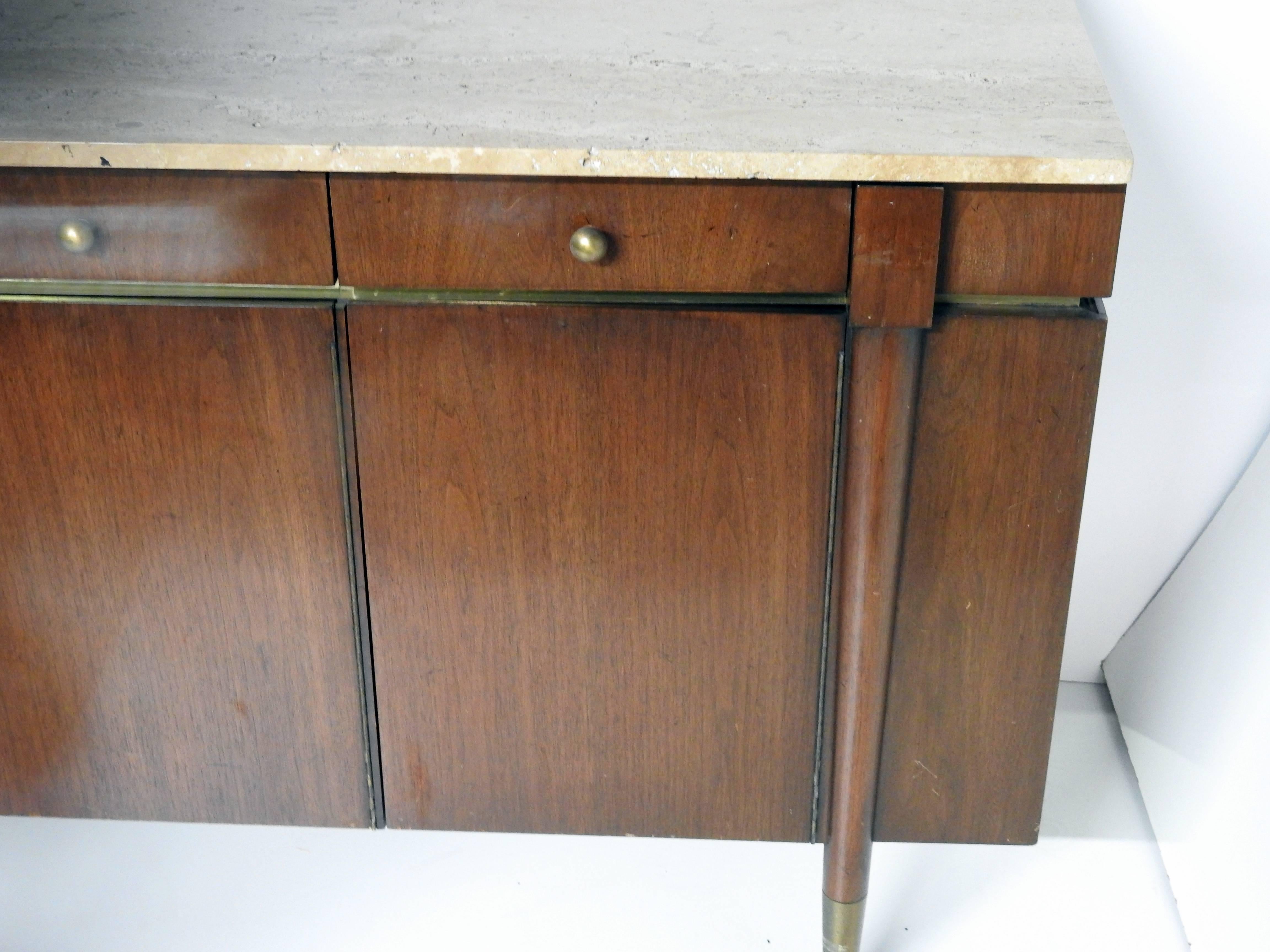 Walnut sideboard with bronze accents, four drawers over doors, and a travertine marble-top.