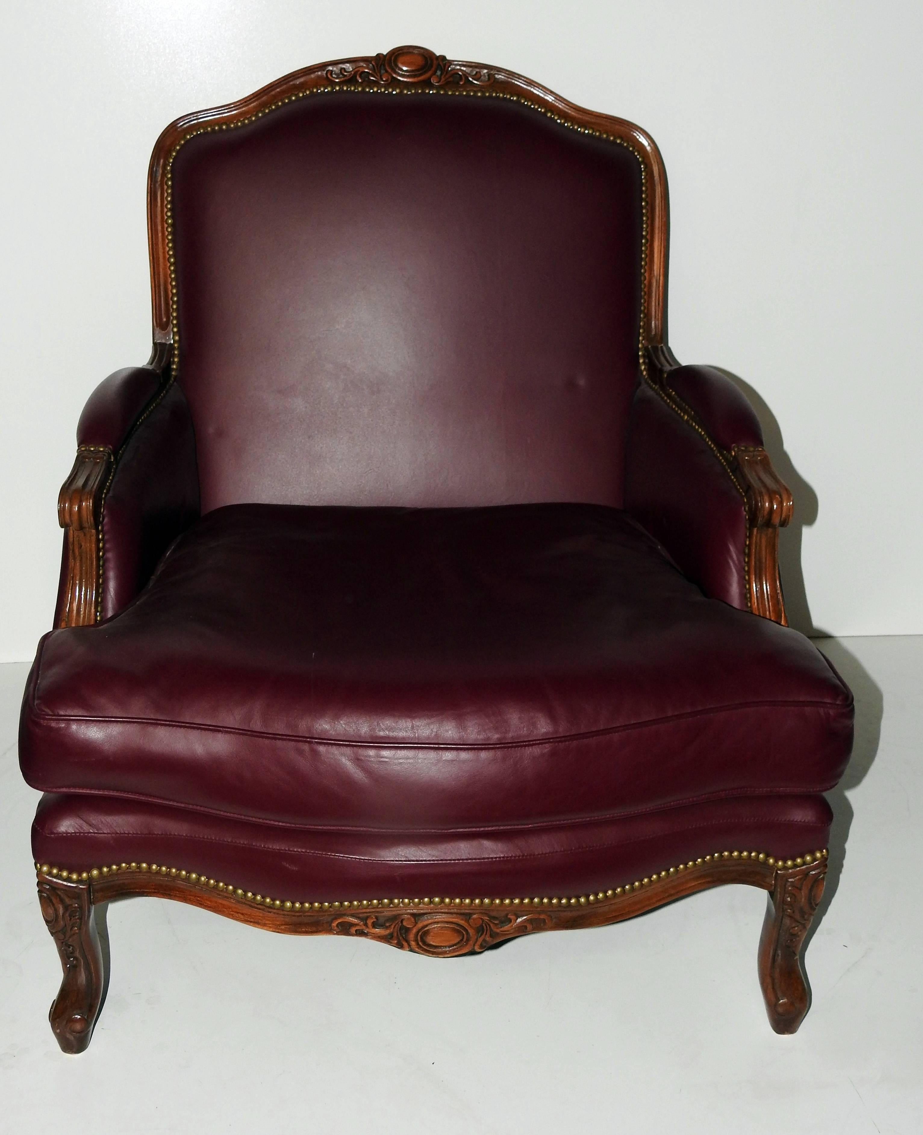 Leather club chair and ottoman with nailhead trim by Baker Furniture. The ottoman measures 33