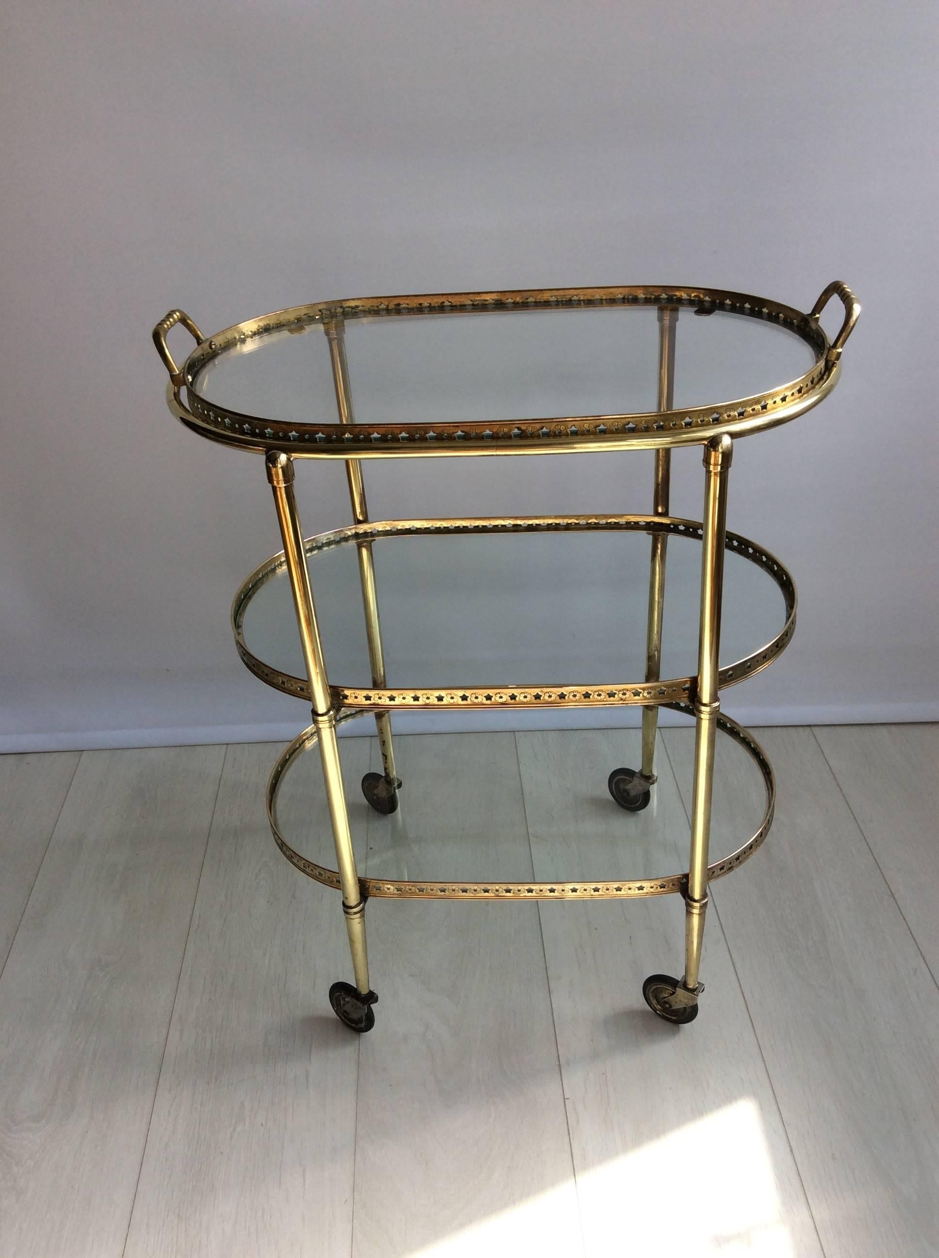 Attractive brass drinks trolley from France, circa 1950.

Star detailing to the lift off tray.

Top tray measures 51cm wide, 30.5cm deep and stands 63cm tall.