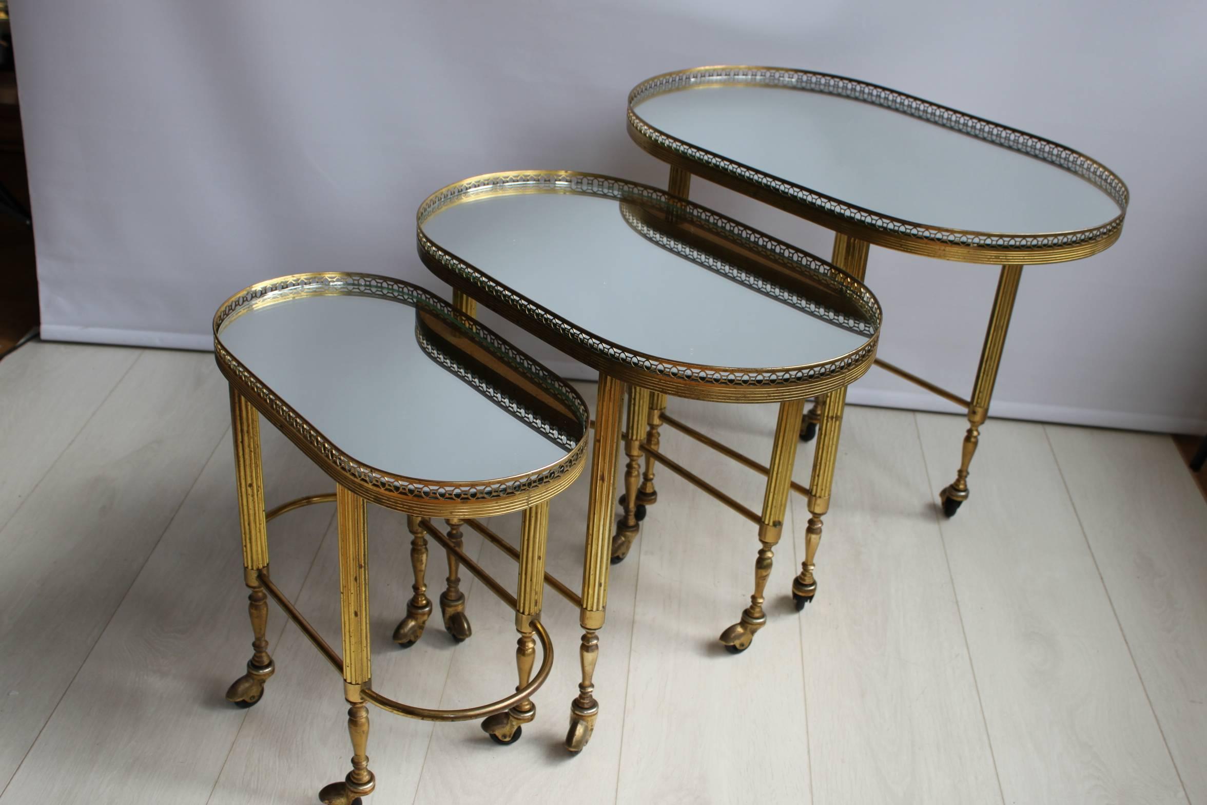 Attractive nest of brass trolleys from France.

Mirrored tops with aged patina to the frame.

Largest trolley measures 61cm wide, 39.5cm deep and 51.5cm tall.
Medium: 52cm wide, 31cm wide, 46cm tall.
Smallest: 43cm wide, 23cm deep, 41.5cm tall.