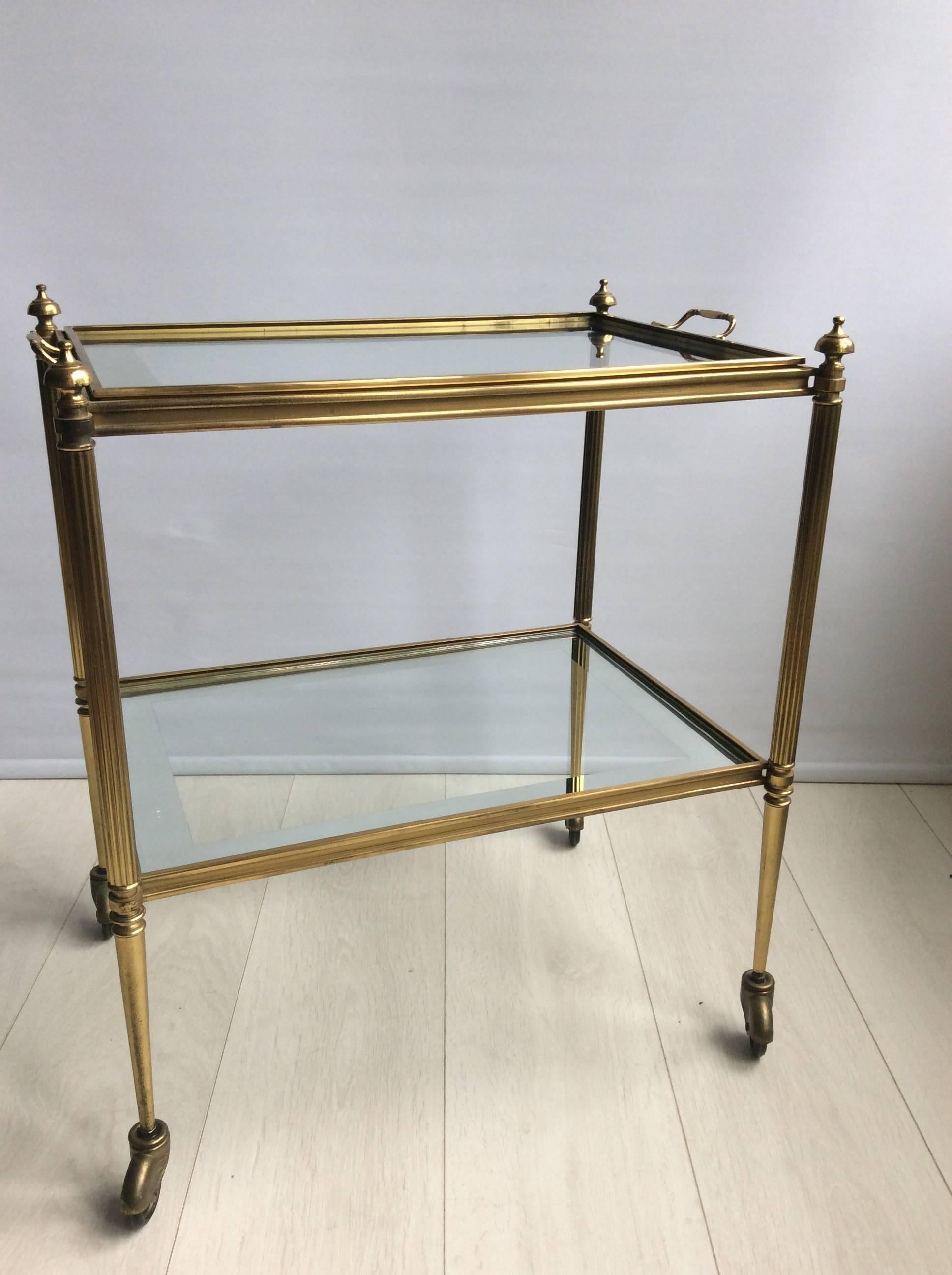 Elegant vintage French drinks trolley with lovely aged patina.

Lift off top tray with mirrored edging to the glass.

Top tray (without handles) measures 49.5cm wide, 34.5cm deep and stands 60cm tall to glass.
Overall dimensions: 56cm wide,
