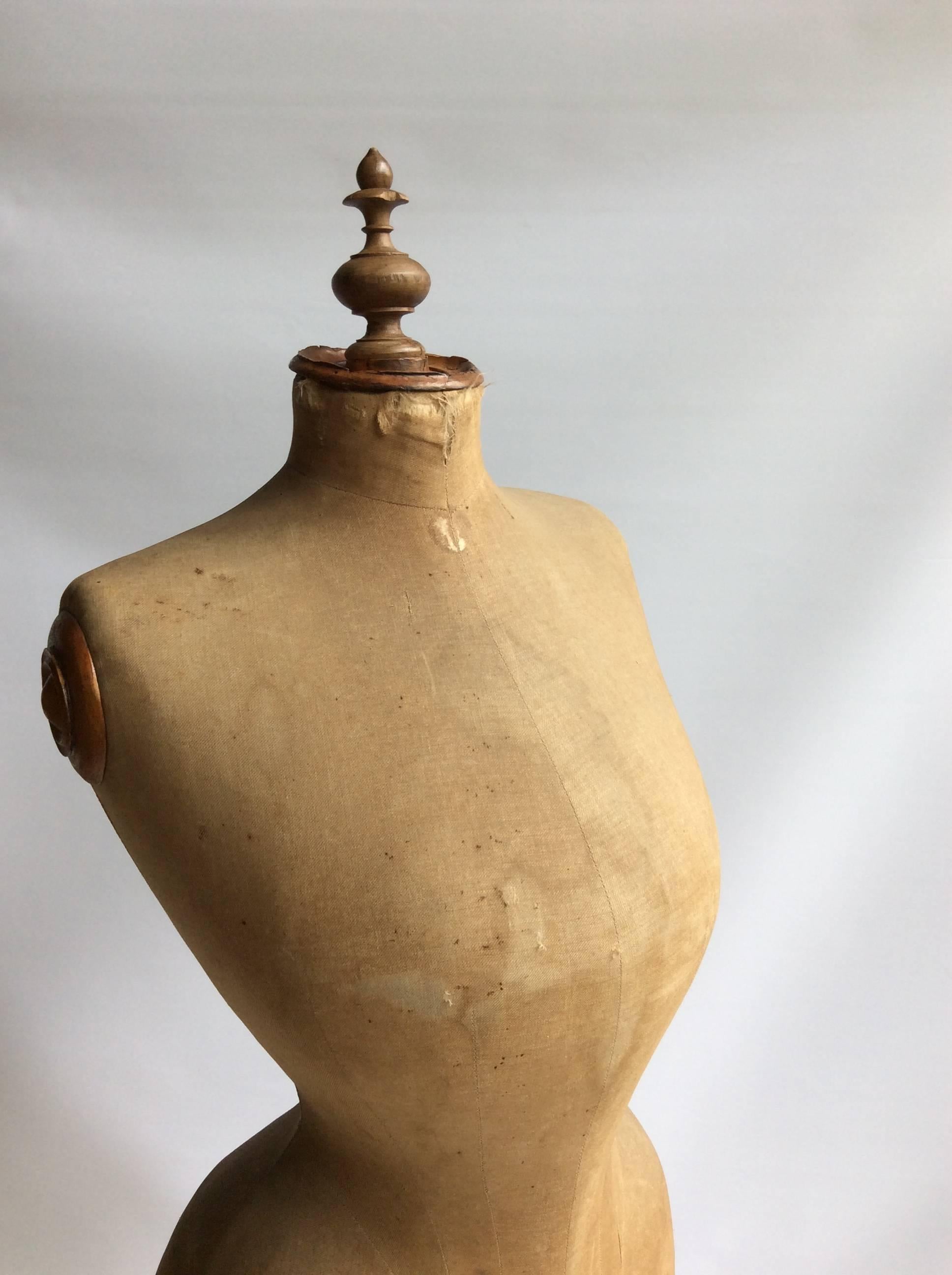 Amazing shape to this wasp waist mannequin, circa 1880s.

On original stand with beautiful initialed fastener.

The fabric is aged and has some marks and tears as per images.
The stand has old woodworm holes.
